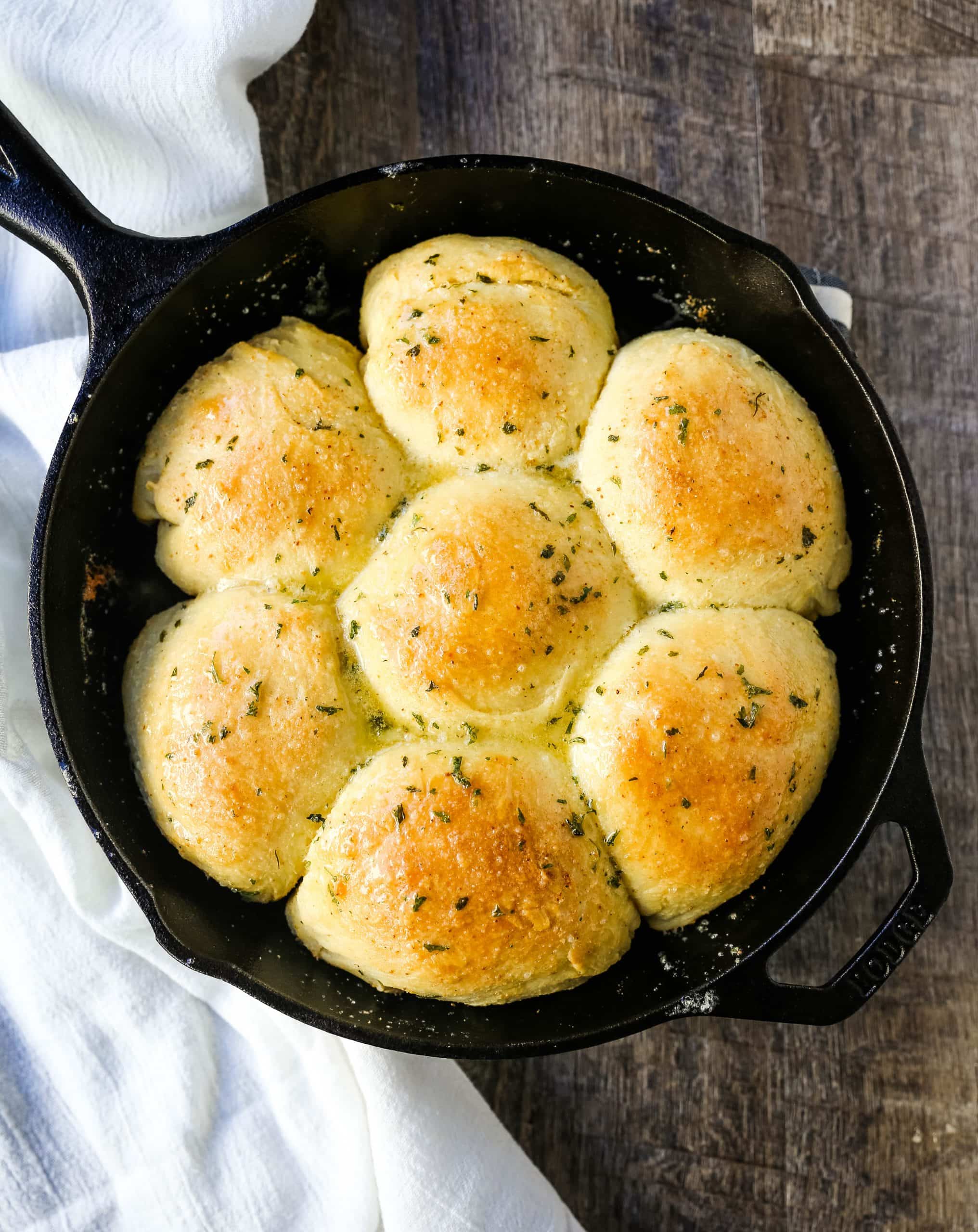 Homemade Garlic Butter Rolls. Made from scratch, fluffy homemade pull-apart rolls slathered in garlic herb butter. The perfect buttery homemade pull-apart rolls recipe! www.modernhoney.com #garlicbutterrolls #homemaderolls #rolls #dinnerrolls #pullapartrolls