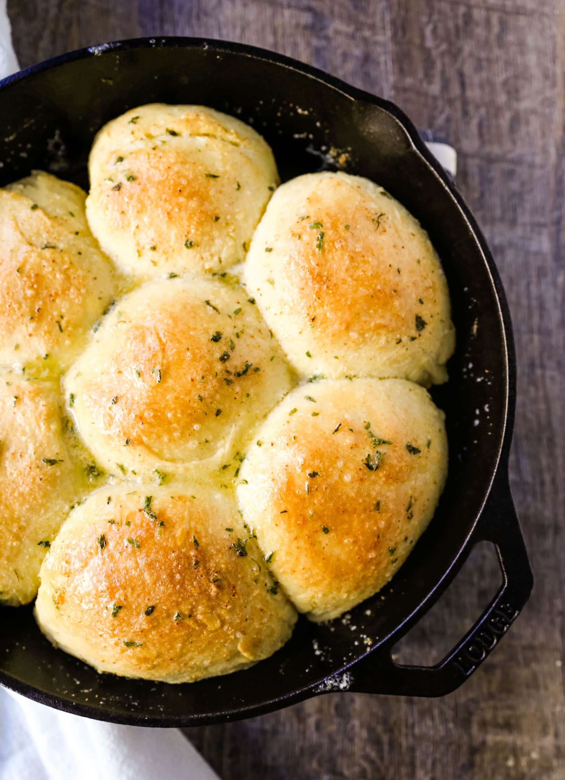 Homemade Garlic Butter Rolls. Made from scratch, fluffy homemade pull-apart rolls slathered in garlic herb butter. The perfect buttery homemade pull-apart rolls recipe! www.modernhoney.com #garlicbutterrolls #homemaderolls #rolls #dinnerrolls #pullapartrolls