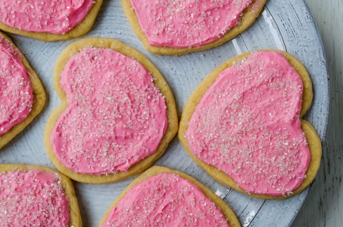 Jacque's Buttery Sugar Cookies. Homemade buttery sugar cookies with sweet buttercream frosting. The perfect frosted sugar cookie recipe! www.modernhoney.com #sugarcookies #buttercookies #buttersugarcookies #heartcookies #valentinesday #valentinesdaycookies