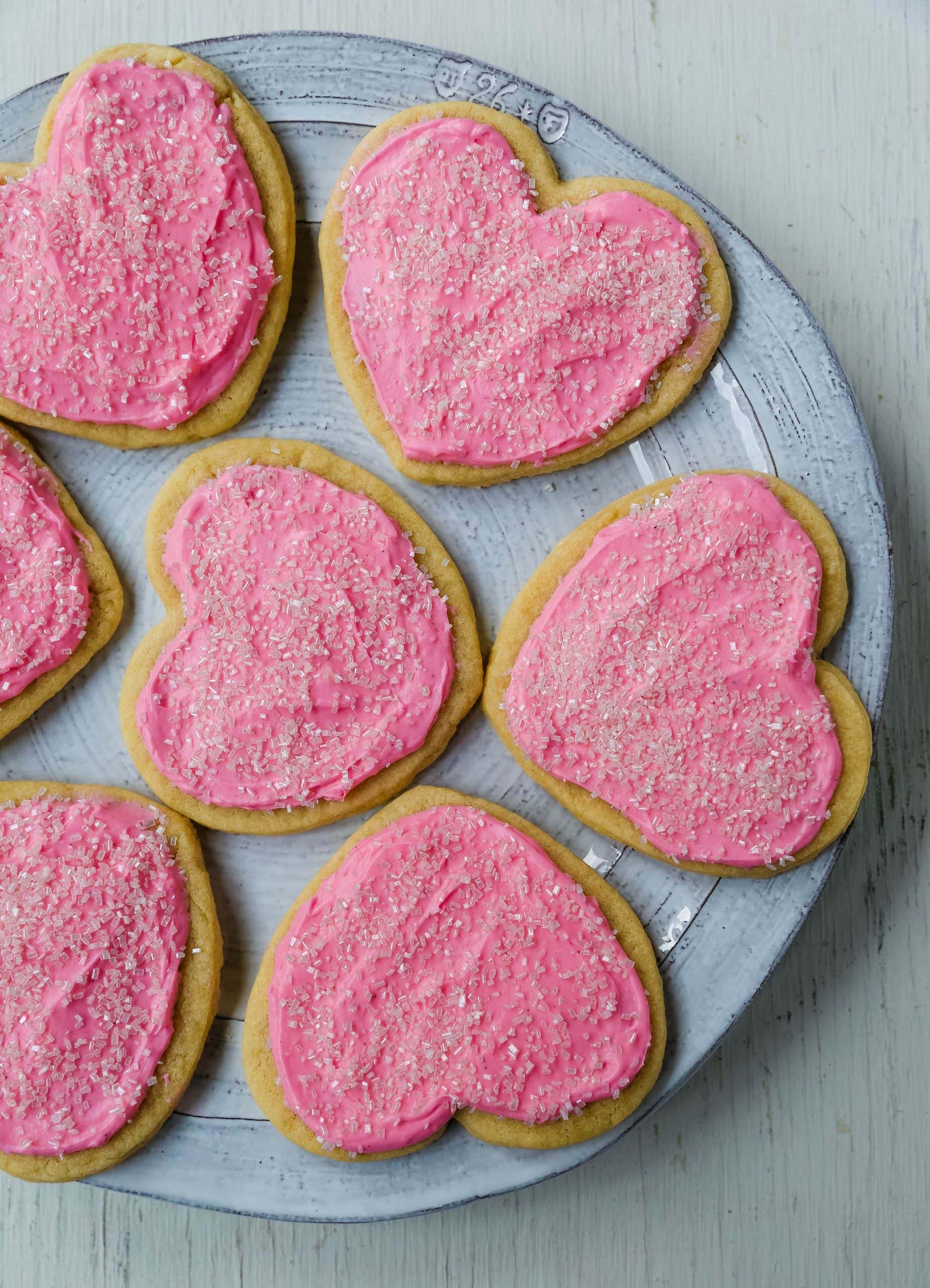 Jacque's Buttery Sugar Cookies. Homemade buttery sugar cookies with sweet buttercream frosting. The perfect frosted sugar cookie recipe! www.modernhoney.com #sugarcookies #buttercookies #buttersugarcookies #heartcookies #valentinesday #valentinesdaycookies