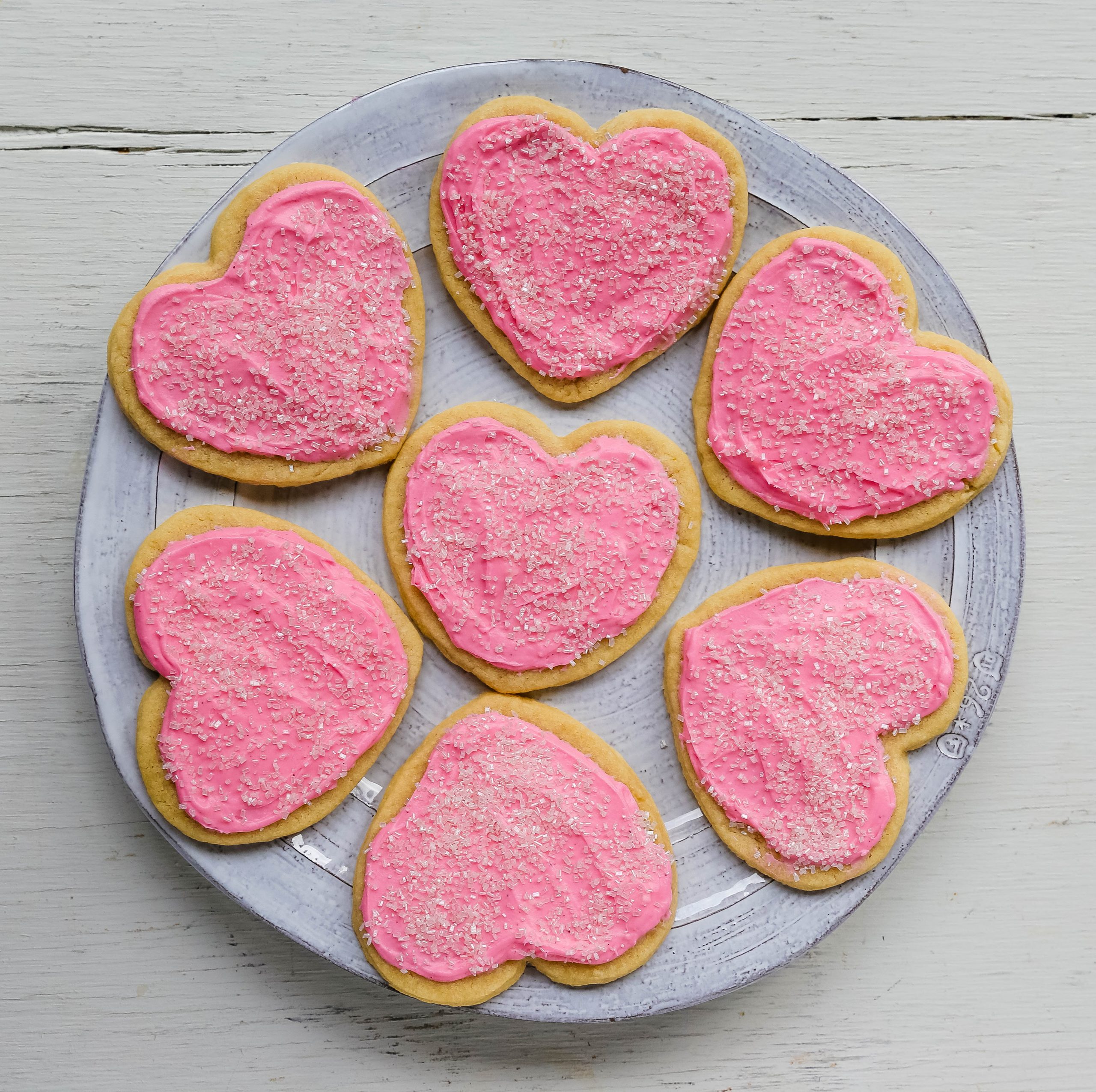 Jacque's Buttery Sugar Cookies. Homemade buttery sugar cookies with sweet buttercream frosting. The perfect frosted sugar cookie recipe! www.modernhoney.com #sugarcookies #buttercookies #buttersugarcookies #heartcookies #valentinesday #valentinesdaycookies