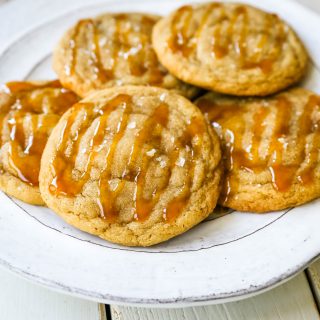 Salted Caramel Cookies Soft chewy caramel cookies with sea salt and drizzled with salted caramel. www.modernhoney.com #cookie #cookies #caramel #caramelcookie #saltedcaramel #seasaltcaramel