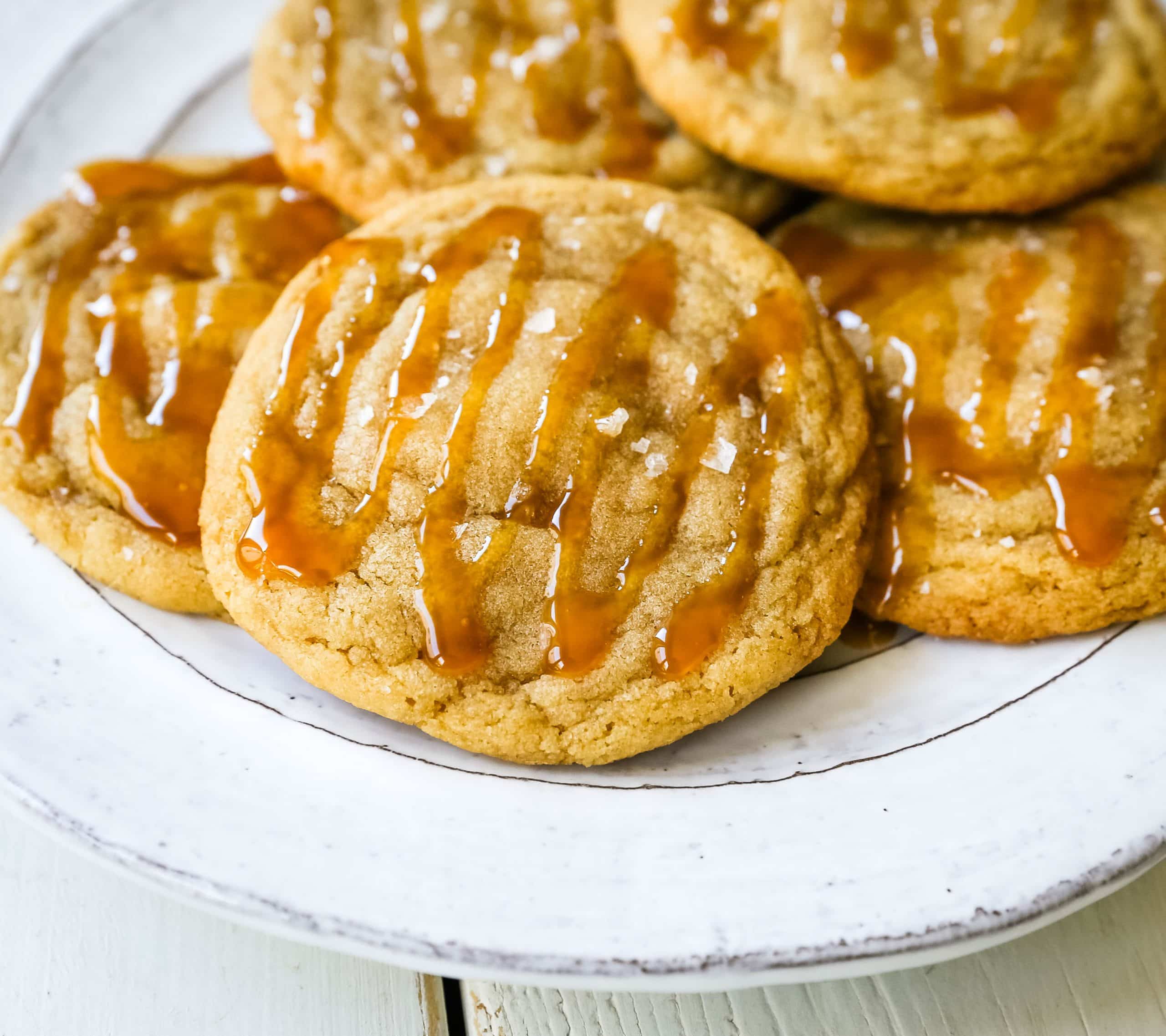 Salted Caramel Cookies Soft chewy caramel cookies with sea salt and drizzled with salted caramel. www.modernhoney.com #cookie #cookies #caramel #caramelcookie #saltedcaramel #seasaltcaramel