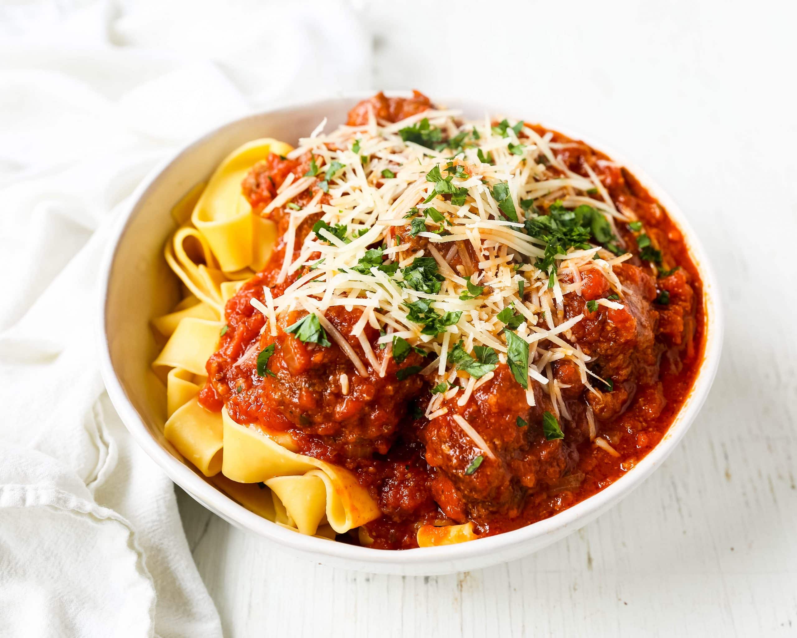 Slow Cooker Meatballs. Tender, moist homemade meatballs made with ground beef, sausage, parmesan cheese, bread crumbs, and spices. Slow cooking the meatballs make the most melt-in-your-mouth meatball! www.modernhoney.com #meatball #meatballs #italian #italianfood #pasta 
