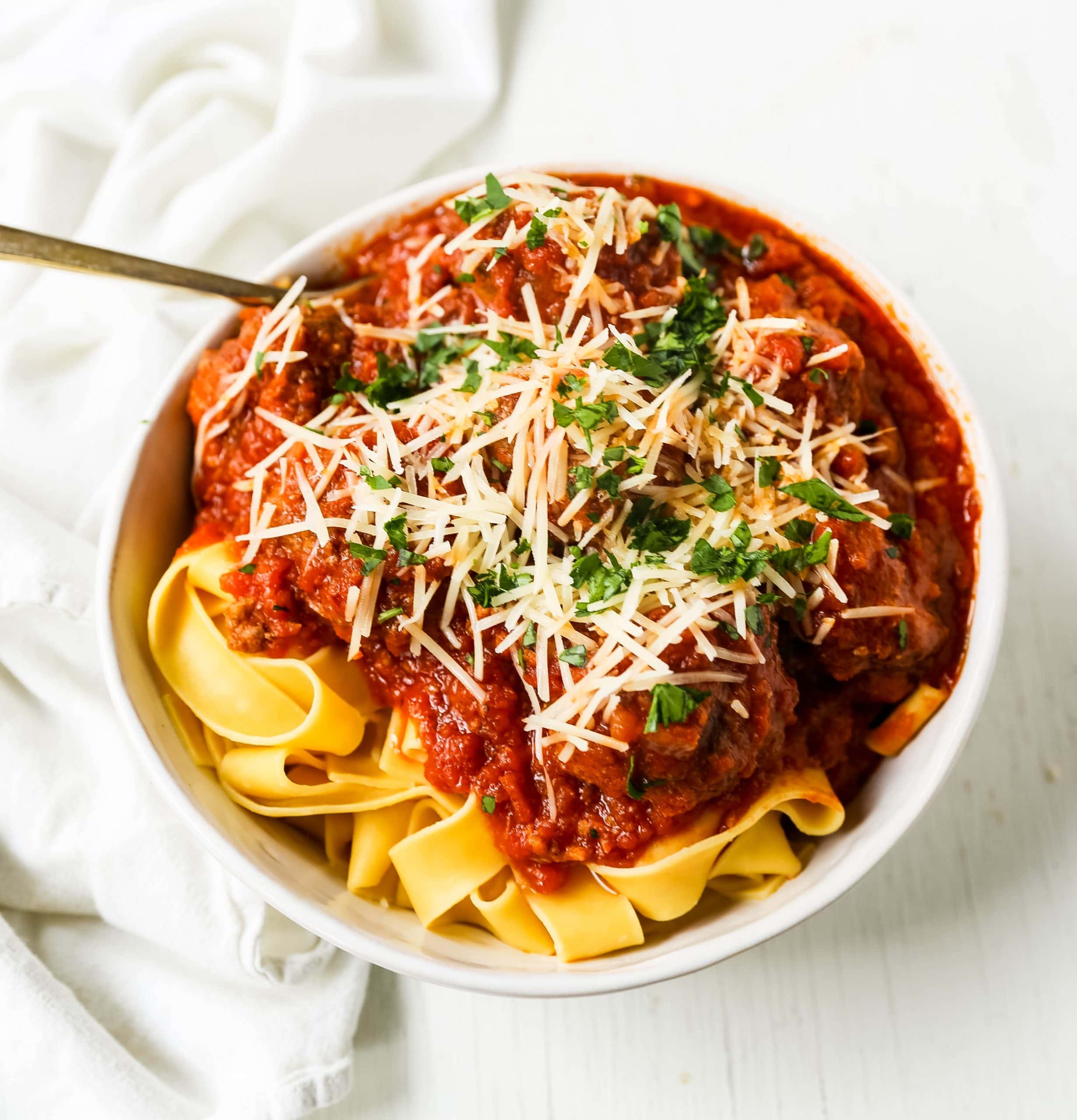 Slow Cooker Meatballs. Tender, moist homemade meatballs made with ground beef, sausage, parmesan cheese, bread crumbs, and spices. Slow cooking the meatballs make the most melt-in-your-mouth meatball! www.modernhoney.com #meatball #meatballs #italian #italianfood #pasta 