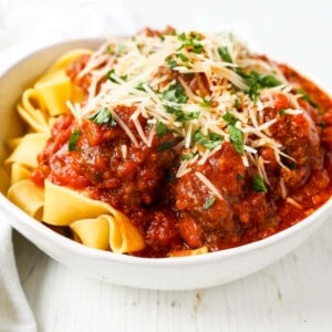 Slow Cooker Meatballs. Tender, moist homemade meatballs made with ground beef, sausage, parmesan cheese, bread crumbs, and spices. Slow cooking the meatballs make the most melt-in-your-mouth meatball! www.modernhoney.com #meatball #meatballs #italian #italianfood #pasta