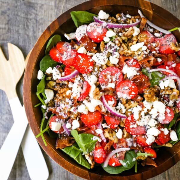 Strawberry Spinach Salad with Poppyseed Dressing Fresh spinach, sliced strawberries, feta cheese, crispy bacon, walnuts, and red onion in a sweet homemade poppyseed dressing. www.modernhoney.com #salad #salads #spinachsalad