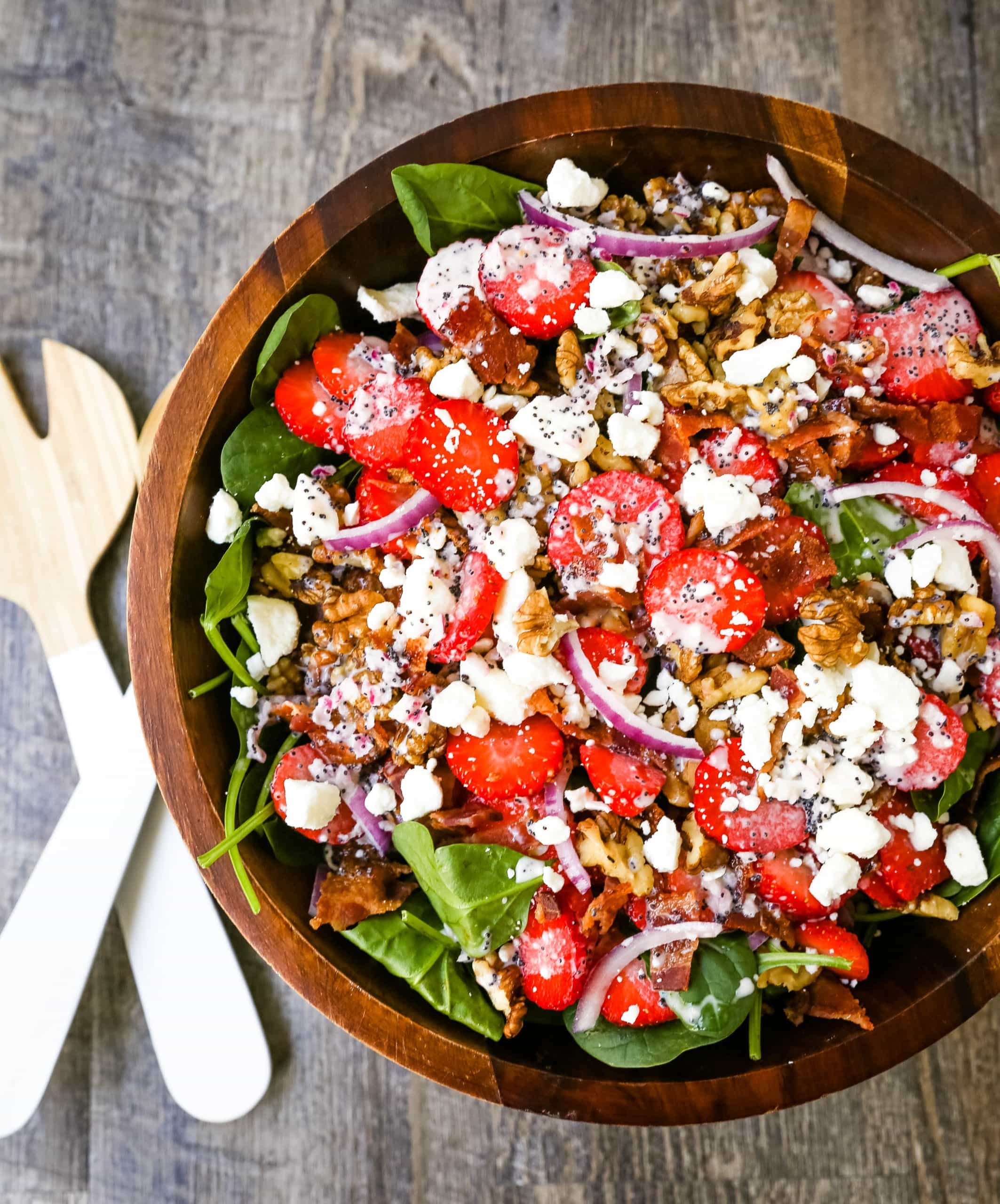 Strawberry Spinach Salad with Poppyseed Dressing Fresh spinach, sliced strawberries, feta cheese, crispy bacon, walnuts, and red onion in a sweet homemade poppyseed dressing. www.modernhoney.com #salad #salads #spinachsalad 