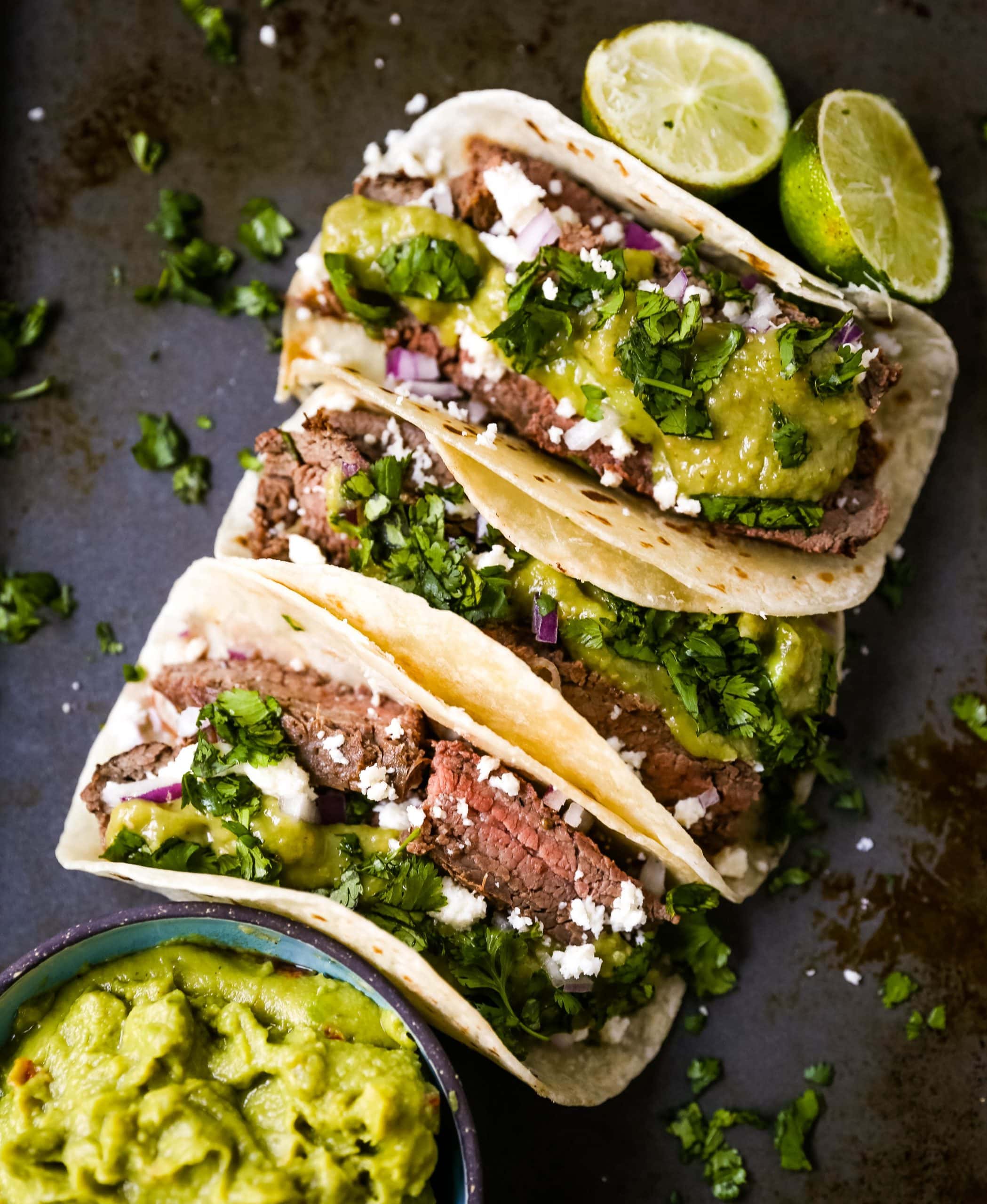 Grilled Steak Tacos. Juicy marinated grilled steak tacos with fresh cilantro, avocado, and salsa. The most flavorful and tender steak tacos recipe! www.modernhoney.com #tacos #steaktacos #steak #beeftacos