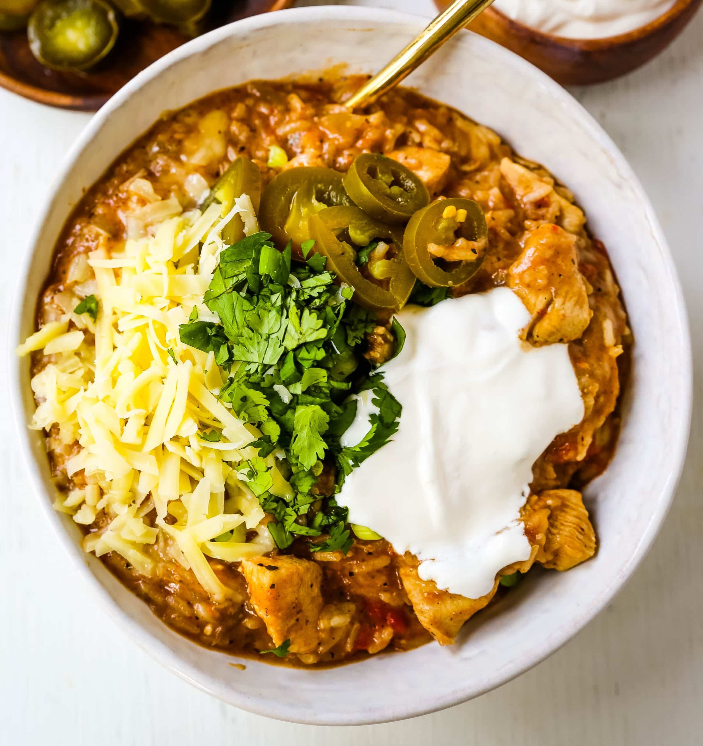 Cheesy Mexican Chicken and Rice Skillet Mexican chicken with green chilies, tomatoes, Mexican spices, rice, and cheese. An easy 30-minute dinner recipe! www.modernhoney.com #skilletdinner #30minutemeal #30minutedinner #mexicanfood #mexican