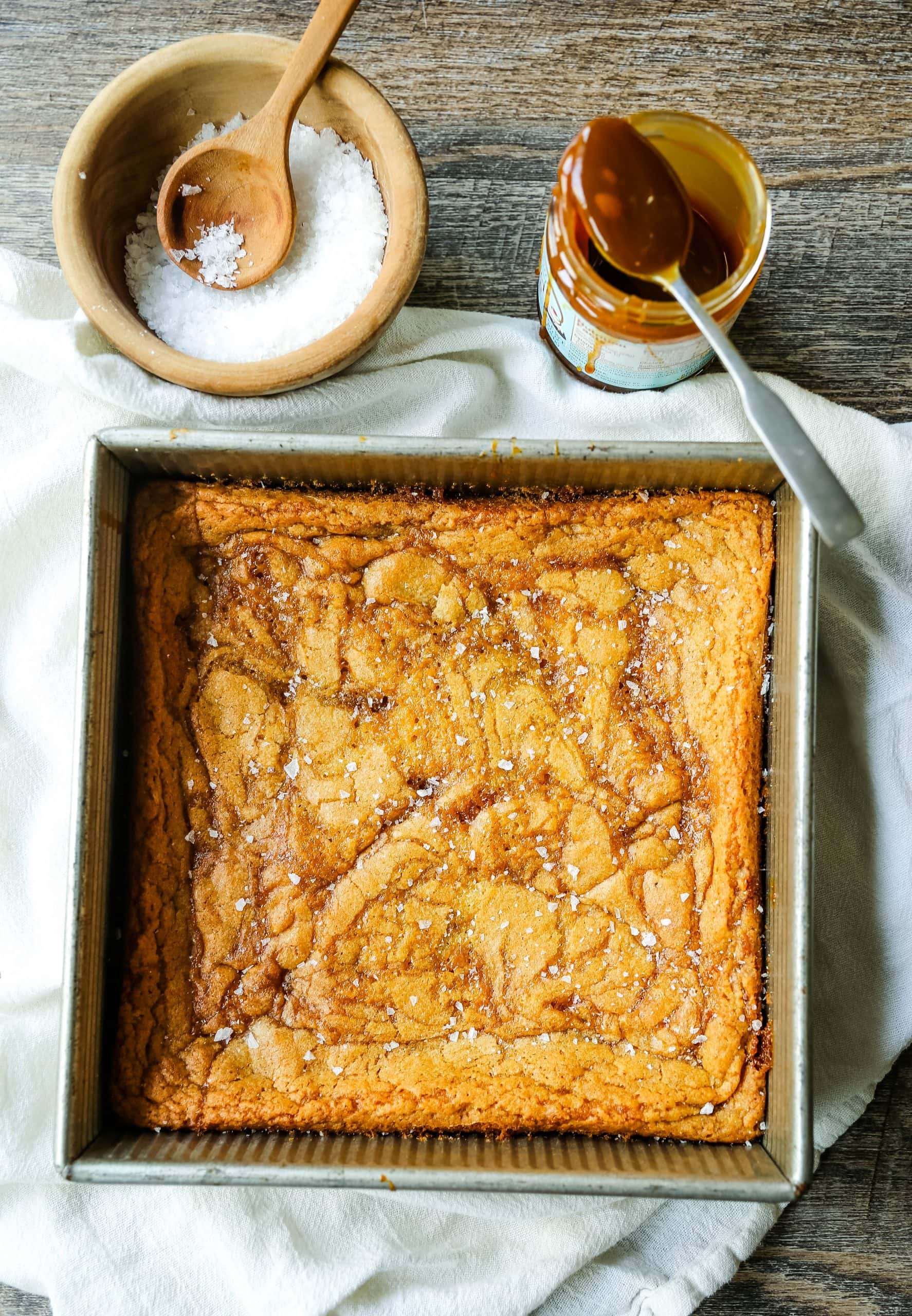 Salted Caramel Blondies. Soft chewy vanilla blondies swirled with salted caramel and baked until golden. The Best Sea Salt Caramel Blondies! www.modernhoney.com #blondies #caramel #caramelblondies #dessertbars