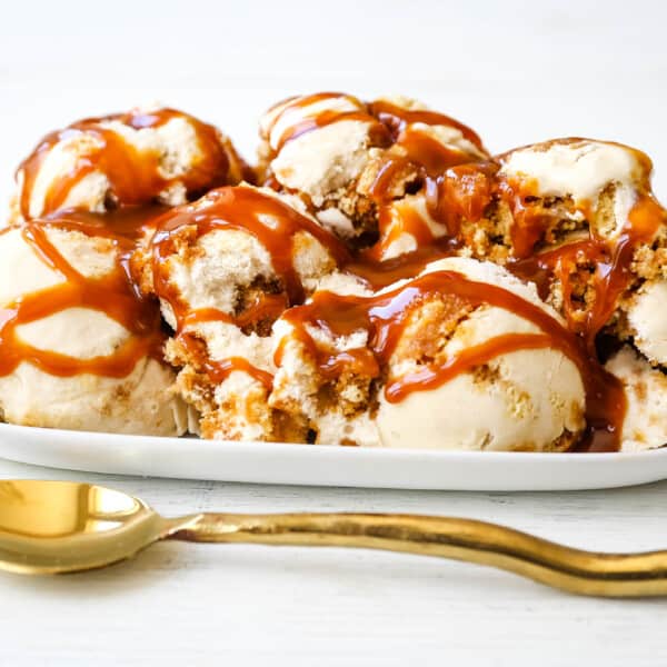 Caramel Gooey Butter Cake Ice Cream. Creamy homemade vanilla ice cream with chunks of homemade butter cake and swirls of decadent sweet caramel. www.modernhoney.com #icecream #homemadeicecream #caramel