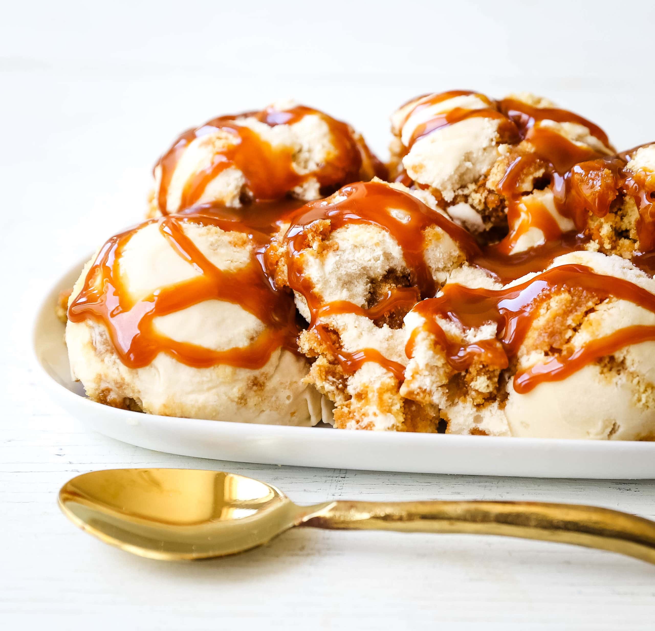 Caramel Gooey Butter Cake Ice Cream. Creamy homemade vanilla ice cream with chunks of homemade butter cake and swirls of decadent sweet caramel. www.modernhoney.com #icecream #homemadeicecream #caramel