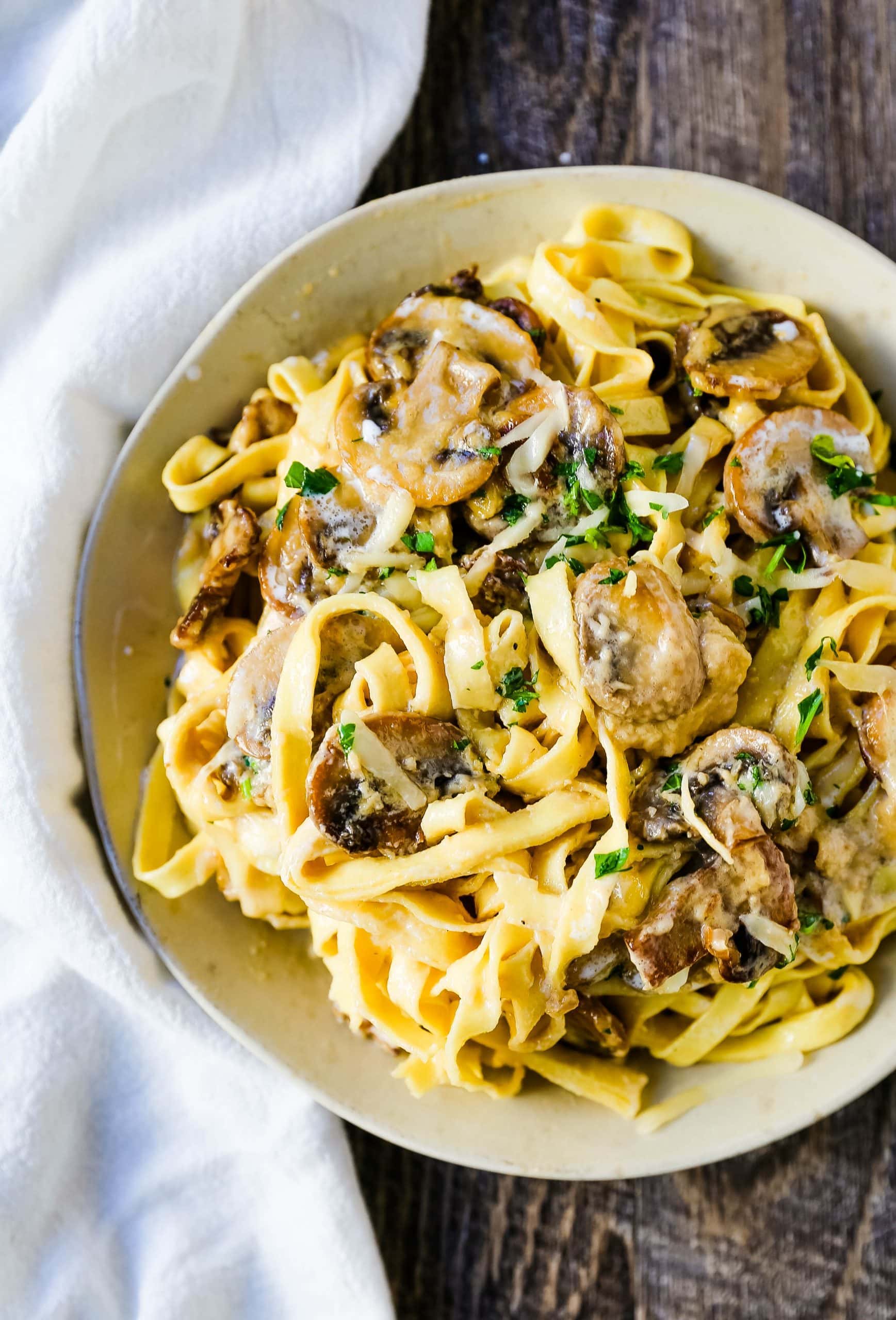 Creamy Mushroom Fettuccine. Sauteed mushrooms in a creamy parmesan cheese alfredo sauce tossed with fettuccine noodles. #mushrooms #fettuccine #mushroomfettuccinealfredo #mushroompasta