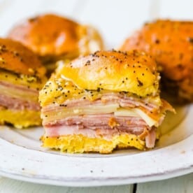 Ham and Cheese Sliders These baked ham and cheese sliders and layered with ham, melted cheese, on a Hawaiian sweet roll, and basted with a flavorful, buttery sauce. www.modernhoney.com #sandwiches #sliders #hamandcheesesliders