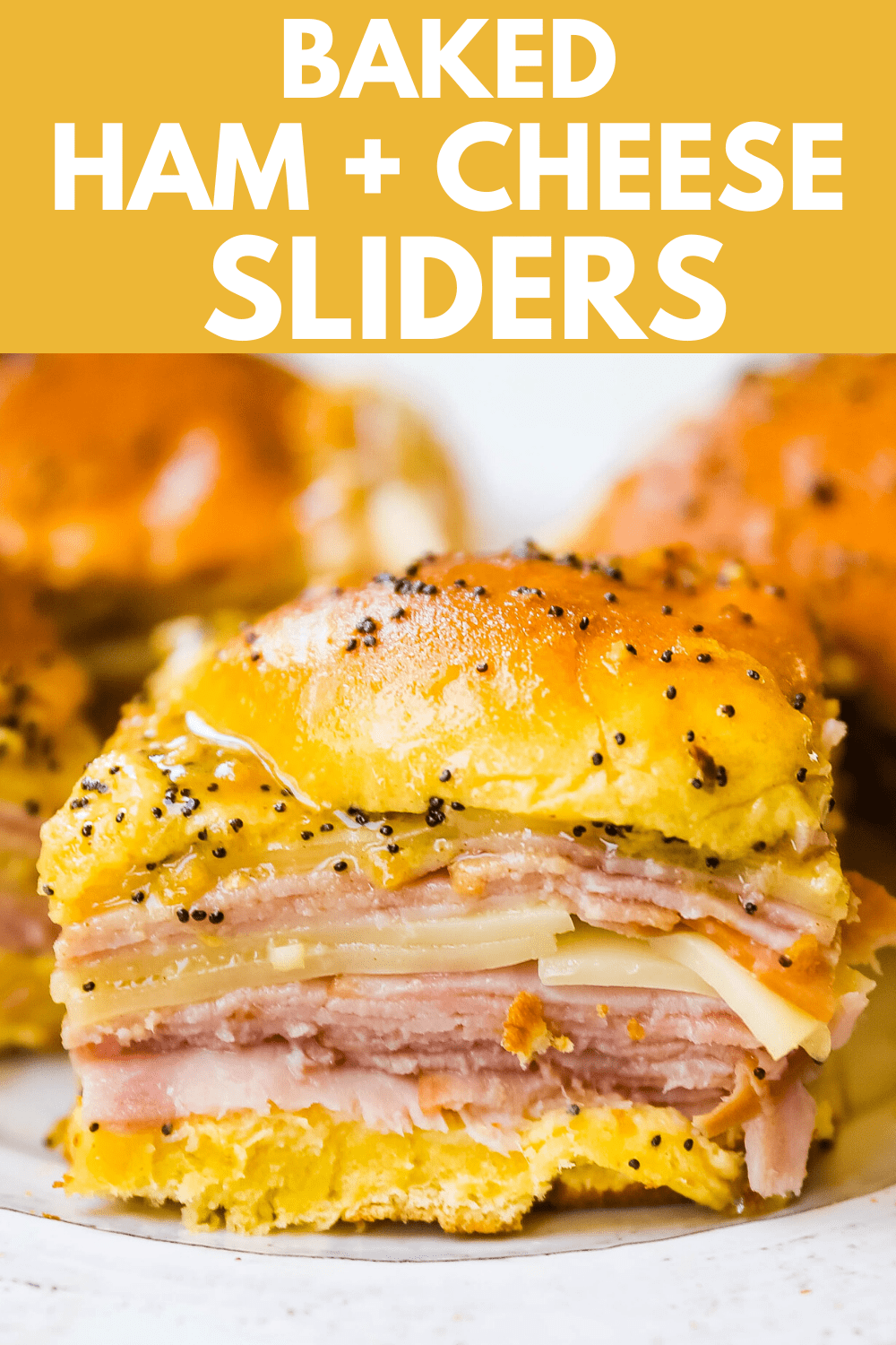 Ham and Cheese Sliders  These baked ham and cheese sliders and layered with ham, melted cheese, on a Hawaiian sweet roll, and basted with a flavorful, buttery sauce. www.modernhoney.com #sandwiches #sliders #hamandcheesesliders