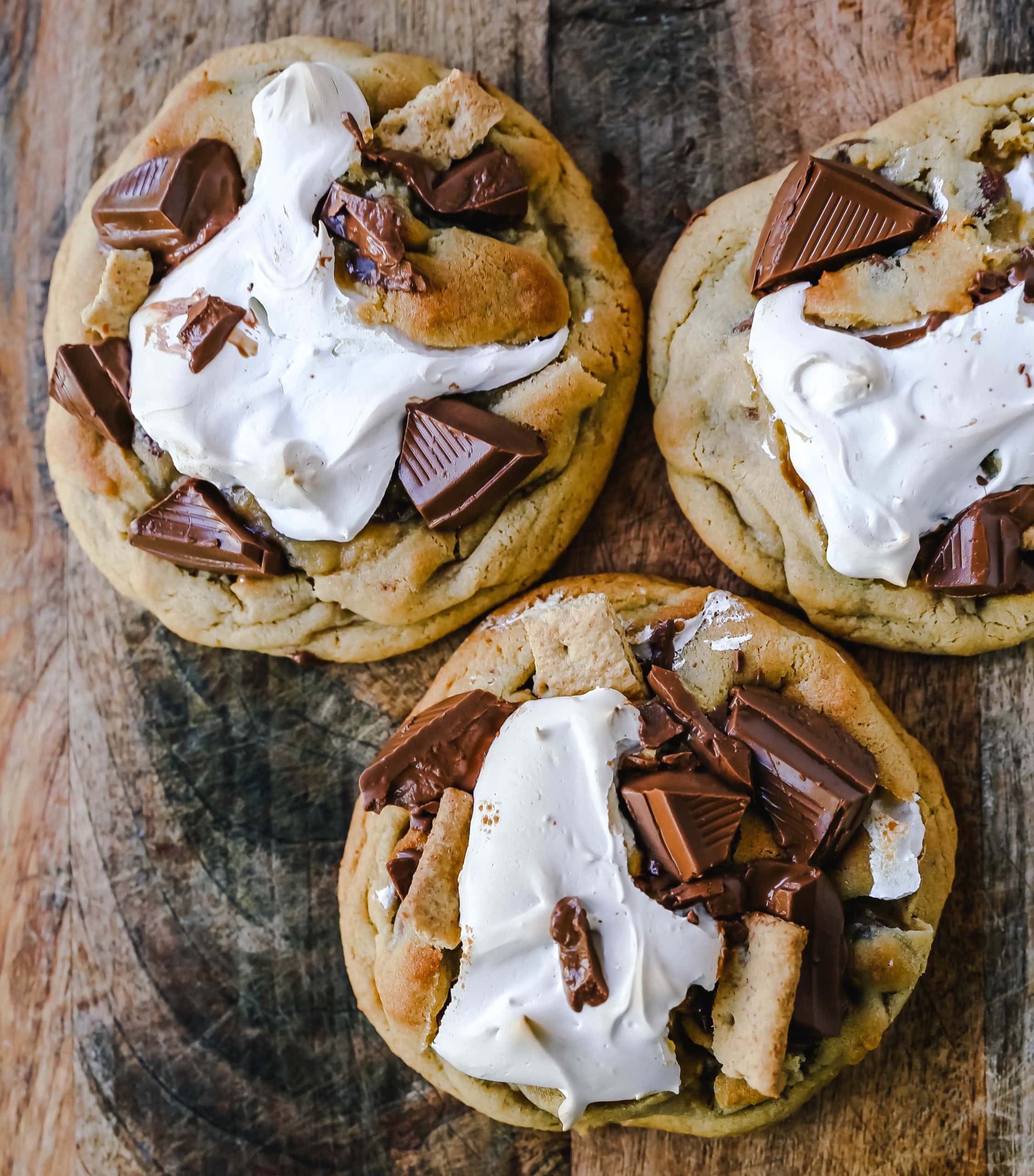 Chocolate Chip S'mores Cookies Warm milk chocolate chip cookies with creamy marshmallow fluff and graham cracker. The most perfect s'mores and chocolate chip cookie in one! www.modernhoney.com #cookies #smores #smorescookies #chocolatechipcookies