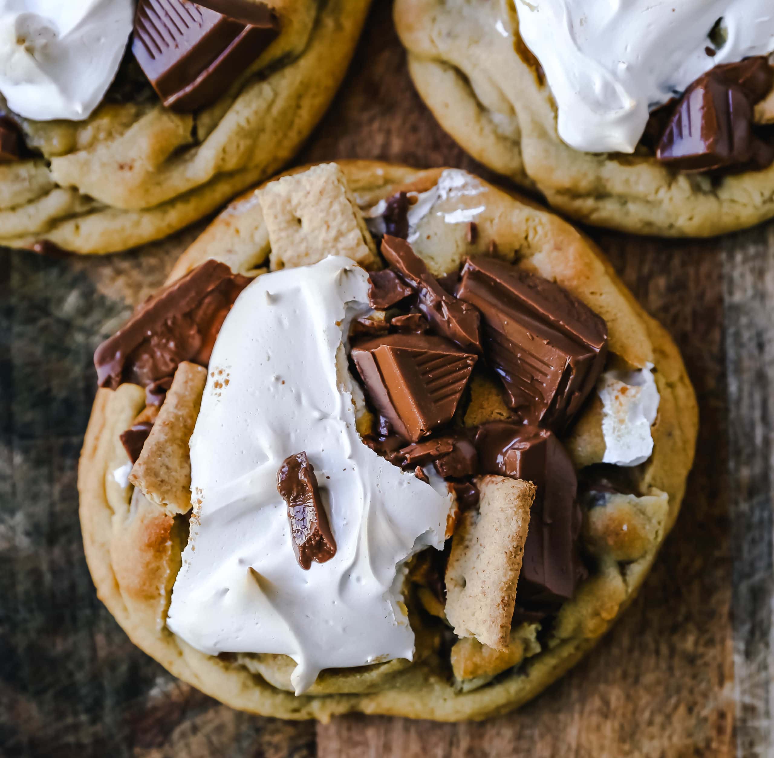 Chocolate Chip S'mores Cookies Warm milk chocolate chip cookies with creamy marshmallow fluff and graham cracker. The most perfect s'mores and chocolate chip cookie in one! www.modernhoney.com #cookies #smores #smorescookies #chocolatechipcookies