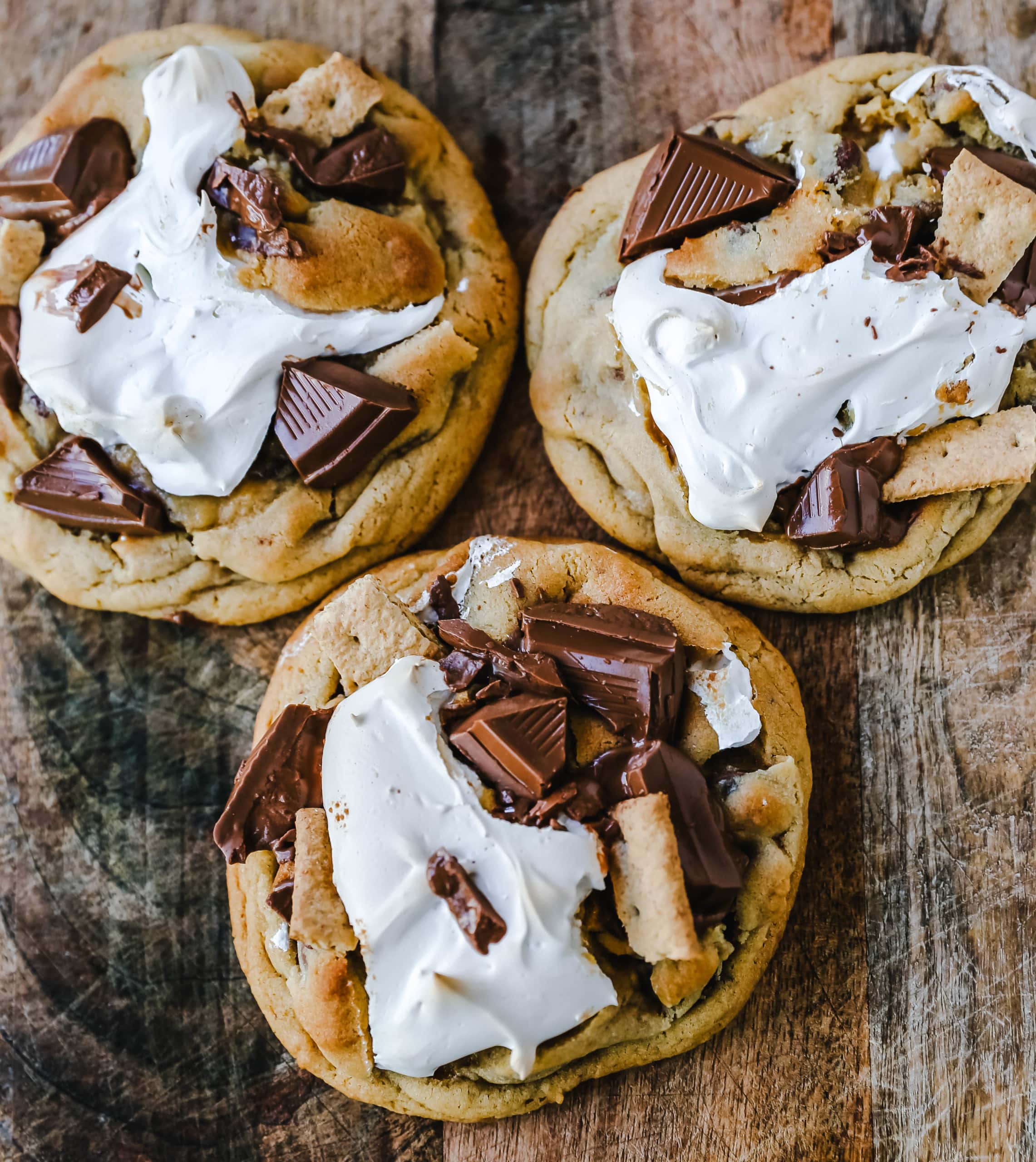 Chocolate Chip S'mores Cookies Warm milk chocolate chip cookies with creamy marshmallow fluff and graham cracker. The most perfect s'mores and chocolate chip cookie in one! www.modernhoney.com #cookies #smores #smorescookies #chocolatechipcookies