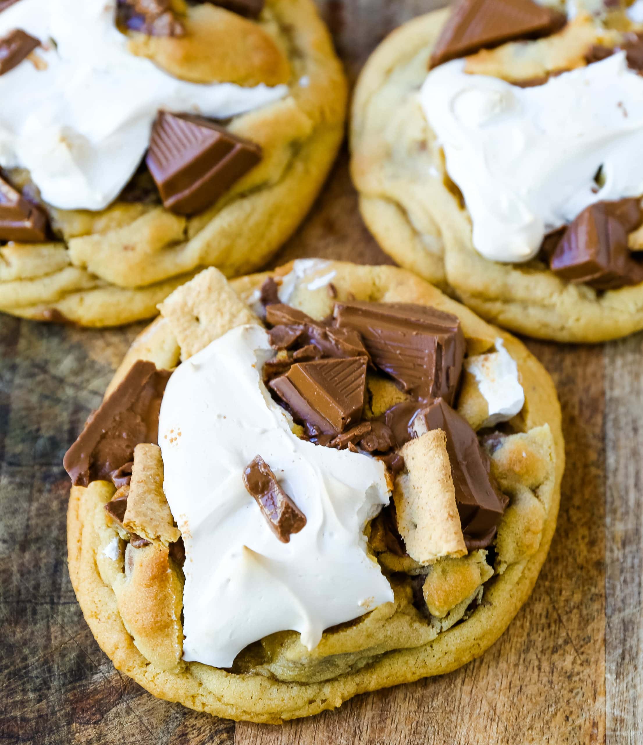 Chocolate Chip S'mores Cookies Warm milk chocolate chip cookies with creamy marshmallow fluff and graham cracker. The most perfect s'mores and chocolate chip cookie in one! www.modernhoney.com #cookies #smores #smorescookies #chocolatechipcookies