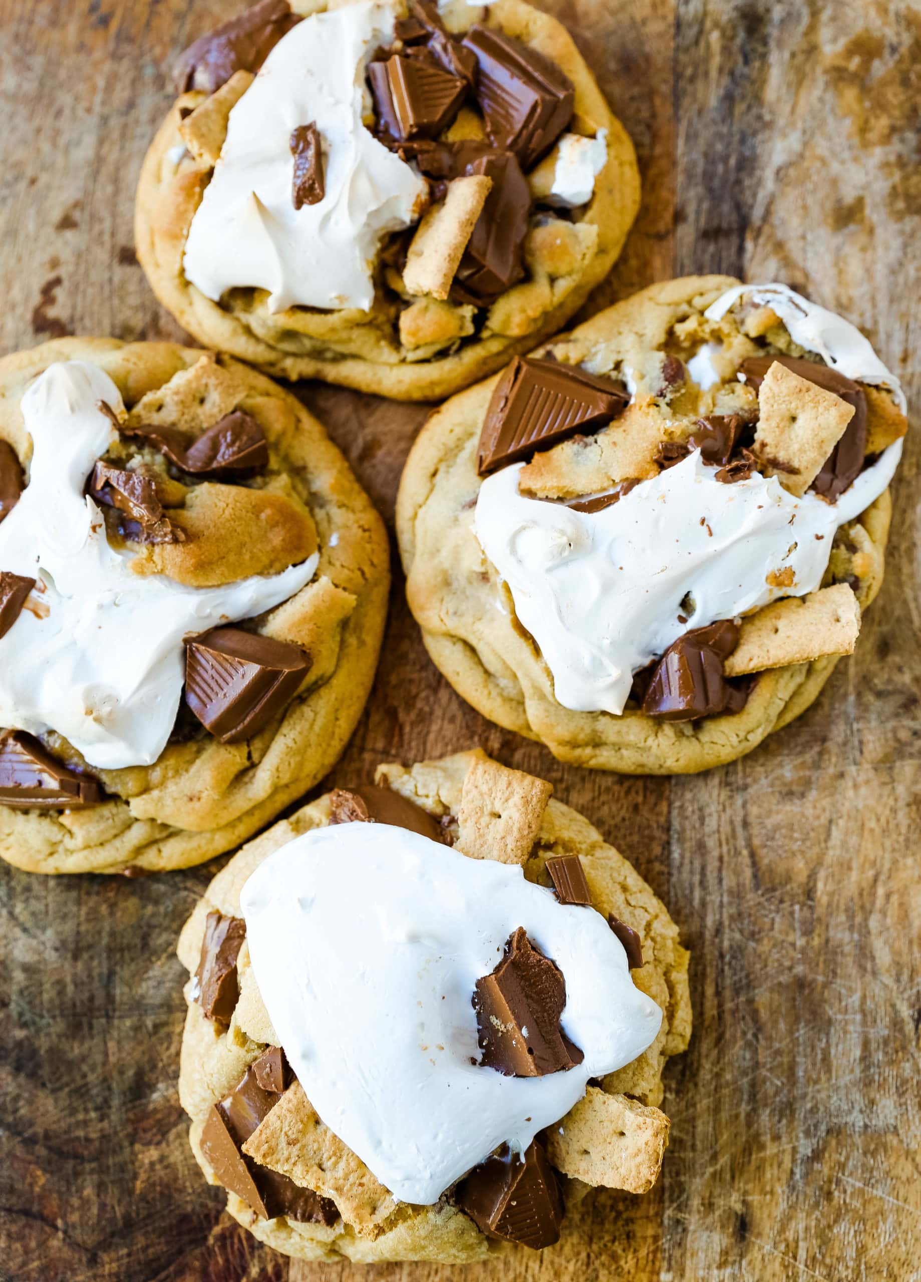 Chocolate Chip S'mores Cookies Warm milk chocolate chip cookies with creamy marshmallow fluff and graham cracker. The most perfect s'mores and chocolate chip cookie in one! www.modernhoney.com #cookies #smores #smorescookies #chocolatechipcookies