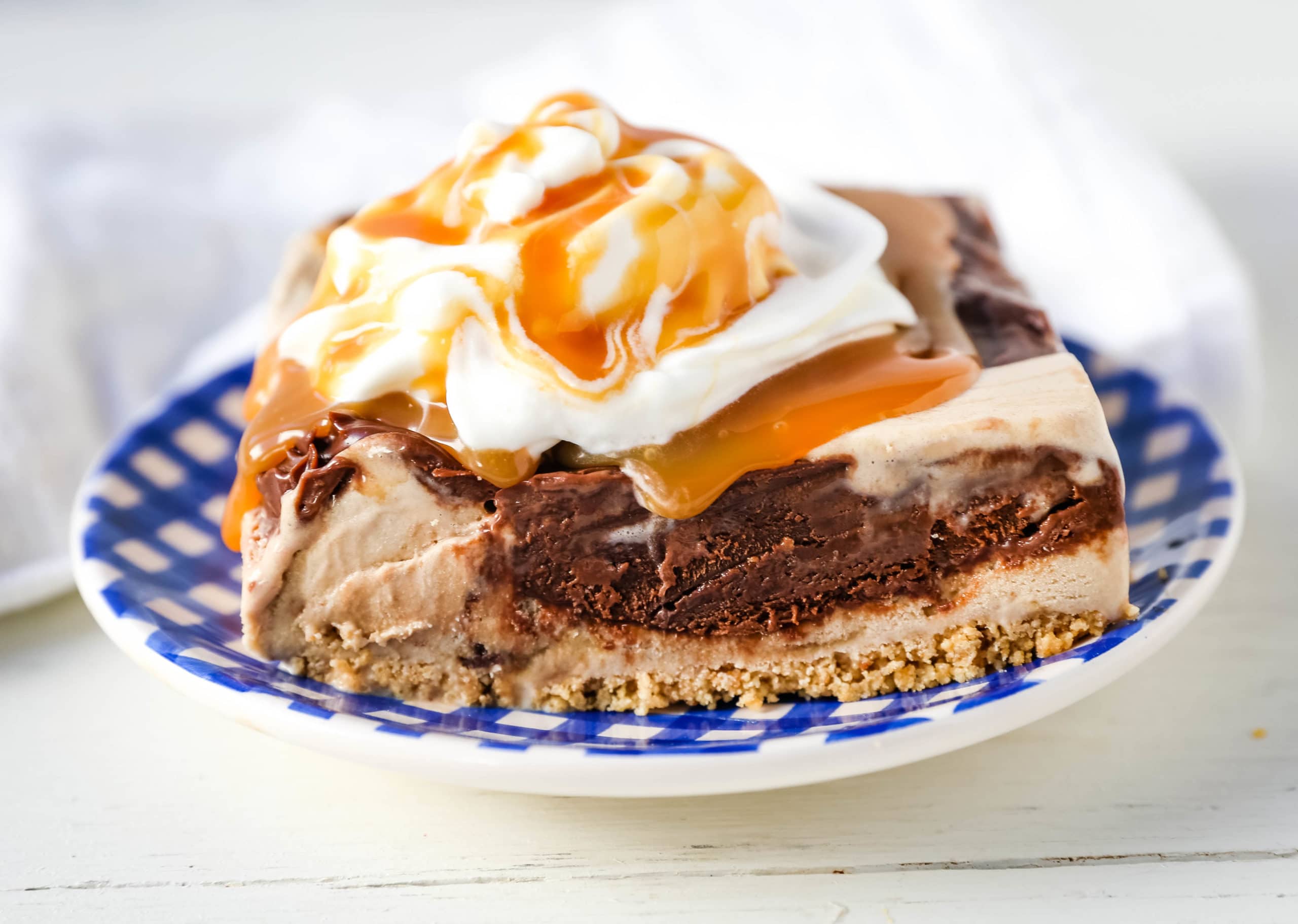 Chocolate Fudge Caramel Ice Cream Dessert Layered ice cream dessert with a sugar cone crust, salted caramel ice cream, hot fudge topping, and freshly whipped cream. The perfect ice cream dessert! #icecream #icecreampie #icecreamdessert