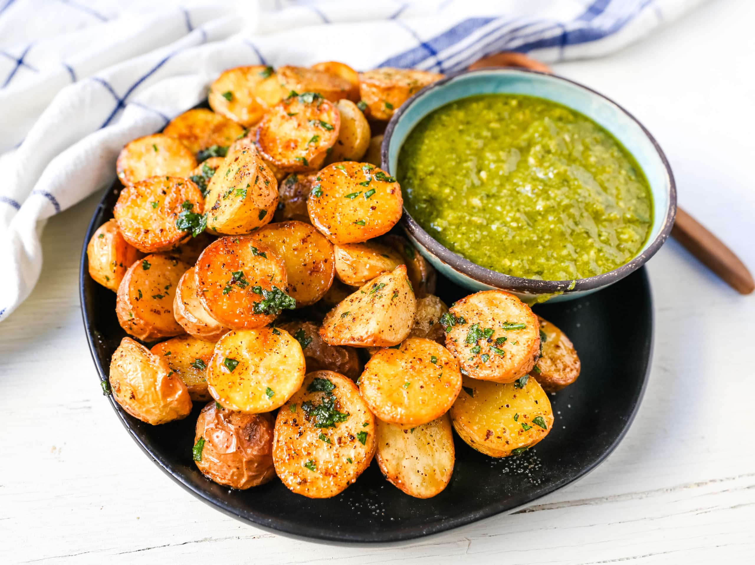 Oven Roasted Potatoes Garlic Roasted Roasted Potatoes with buttery Yukon gold potatoes baked with olive oil, garlic butter, and sprinkled with fresh parsley. The Best Roasted Potatoes recipe! www.modernhoney.com #potatoes #roastedpotatoes #sidedish