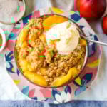 Peach Crisp. Fresh sweetened peaches with a brown sugar oat crumble topping with creamy vanilla ice cream. The perfect summer dessert! www.modernhoney.com #peach #peaches #peachcrisp #peachrecipes #peachdessert
