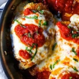 Chicken Parmesan. Panko-crusted chicken breast topped with homemade marinara sauce, melted whole milk mozzarella, and parmesan cheeses and baked until golden and bubbly. www.modernhoney.com #chicken #chickenparmesan #italian