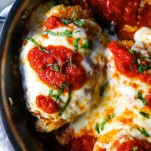 Chicken Parmesan. Panko-crusted chicken breast topped with homemade marinara sauce, melted whole milk mozzarella, and parmesan cheeses and baked until golden and bubbly. www.modernhoney.com #chicken #chickenparmesan #italian