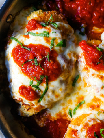 Chicken Parmesan. Panko-crusted chicken breast topped with homemade marinara sauce, melted whole milk mozzarella, and parmesan cheeses and baked until golden and bubbly. www.modernhoney.com #chicken #chickenparmesan #italian