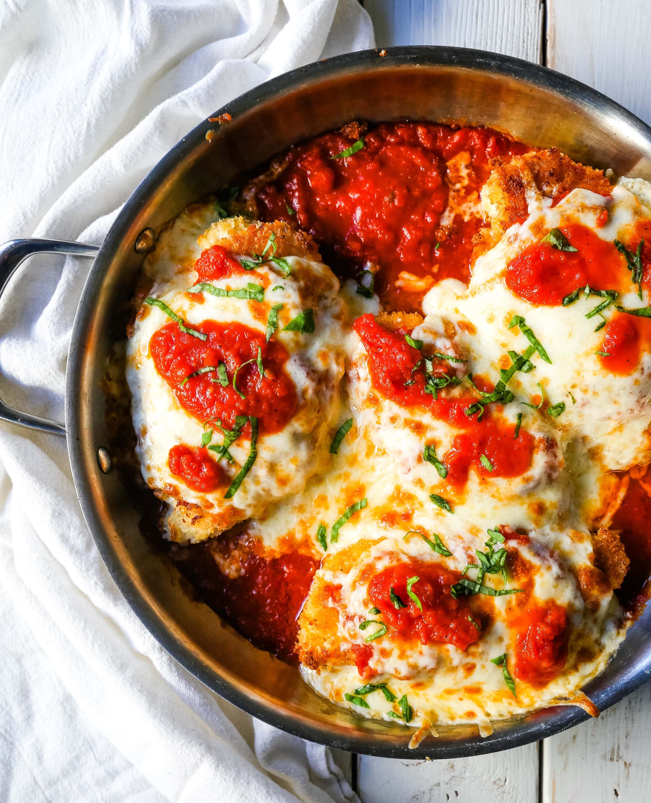 Chicken Parmesan. Panko-crusted chicken breast topped with homemade marinara sauce, melted whole milk mozzarella, and parmesan cheeses and baked until golden and bubbly. www.modernhoney.com #chicken #chickenparmesan #italian