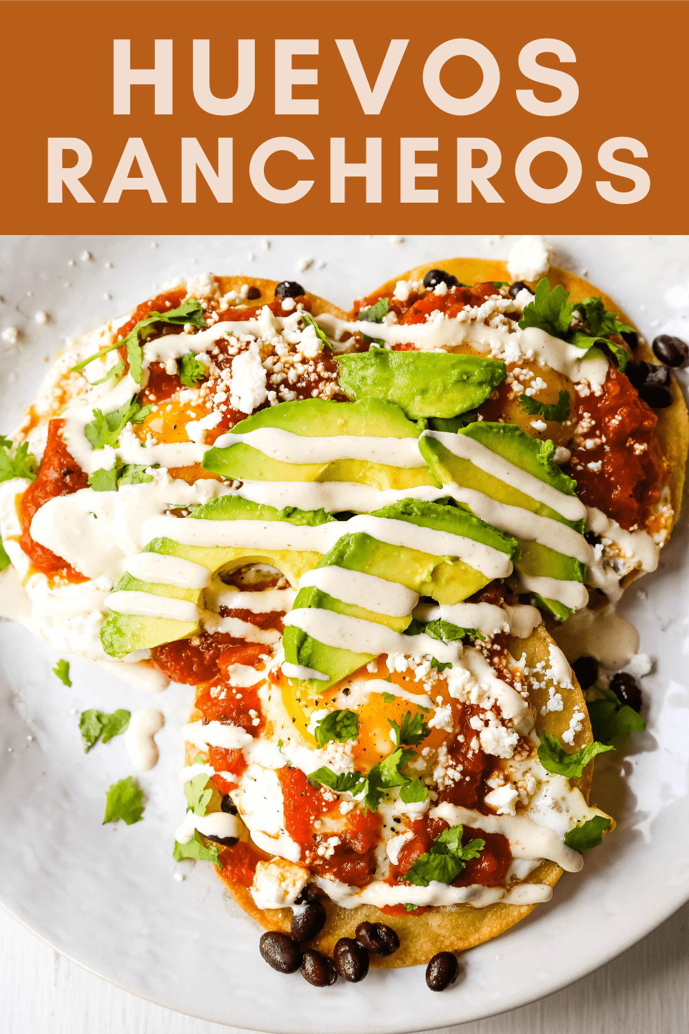 Huevos Rancheros. A traditional Mexican breakfast dish made with fried corn tortillas, fried egg, ranchera salsa, beans, avocado, cheese, and salsa.  #huevosrancheros #mexican #mexicanfood #breakfast
