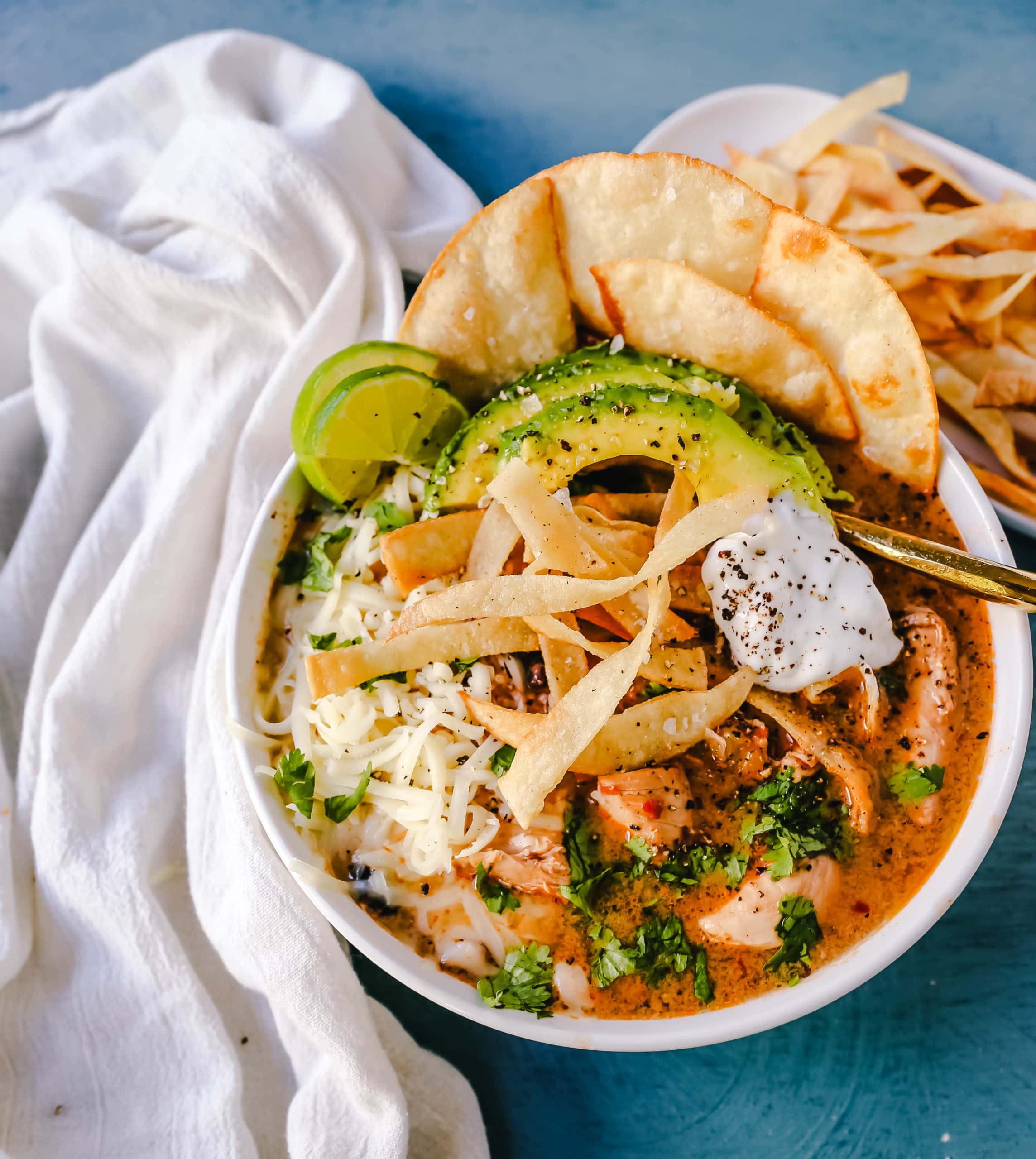 Slow Cooker Creamy Chicken Tortilla Soup Creamy, spicy, warm, and comforting creamy chicken tortilla soup all made in a crockpot! The best crockpot creamy chicken tortilla soup recipe! www.modernhoney.com #soup #chickentortillasoup #mexicanfood