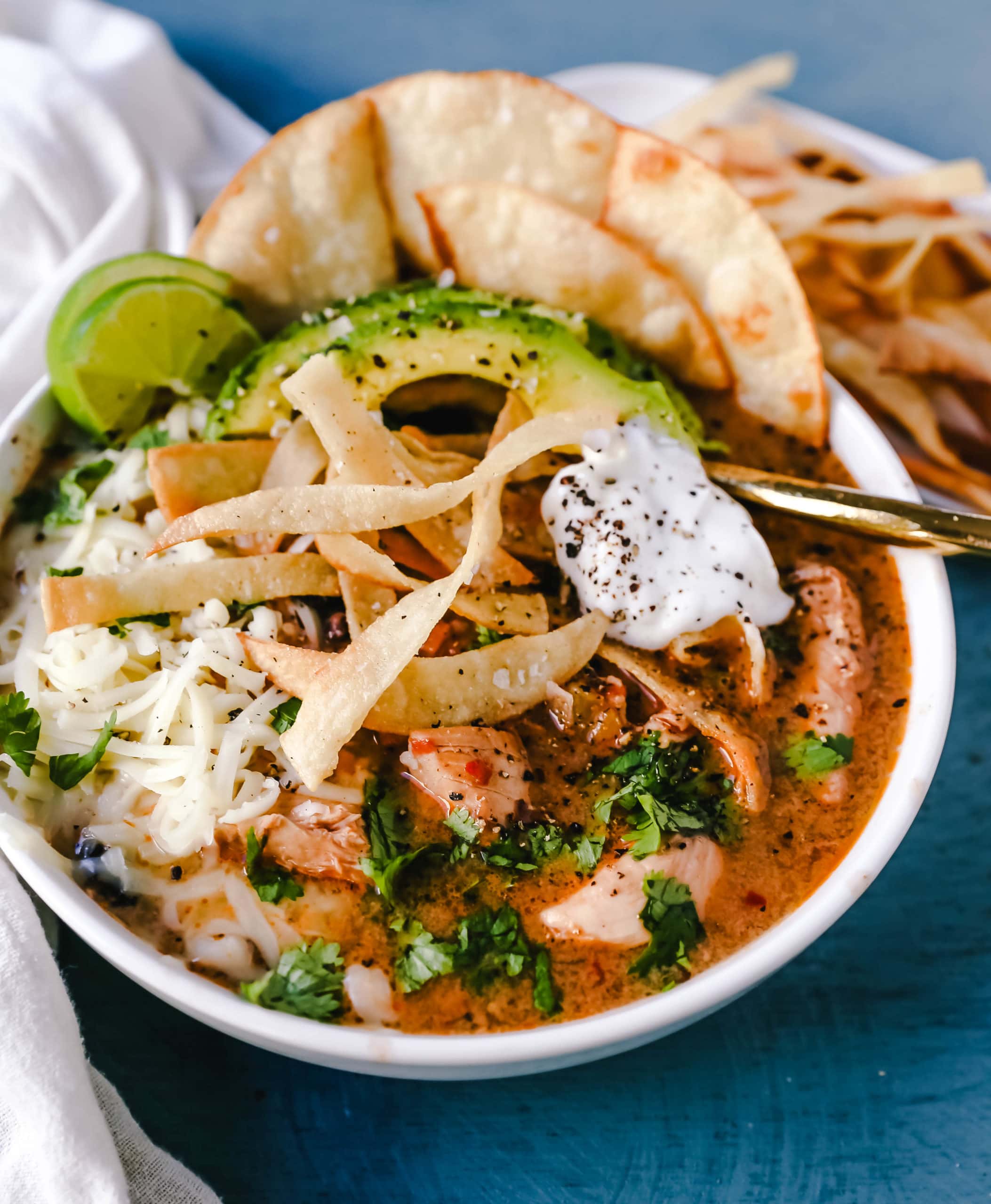 Slow Cooker Creamy Chicken Tortilla Soup Creamy, spicy, warm, and comforting creamy chicken tortilla soup all made in a crockpot! The best crockpot creamy chicken tortilla soup recipe! www.modernhoney.com #soup #chickentortillasoup #mexicanfood