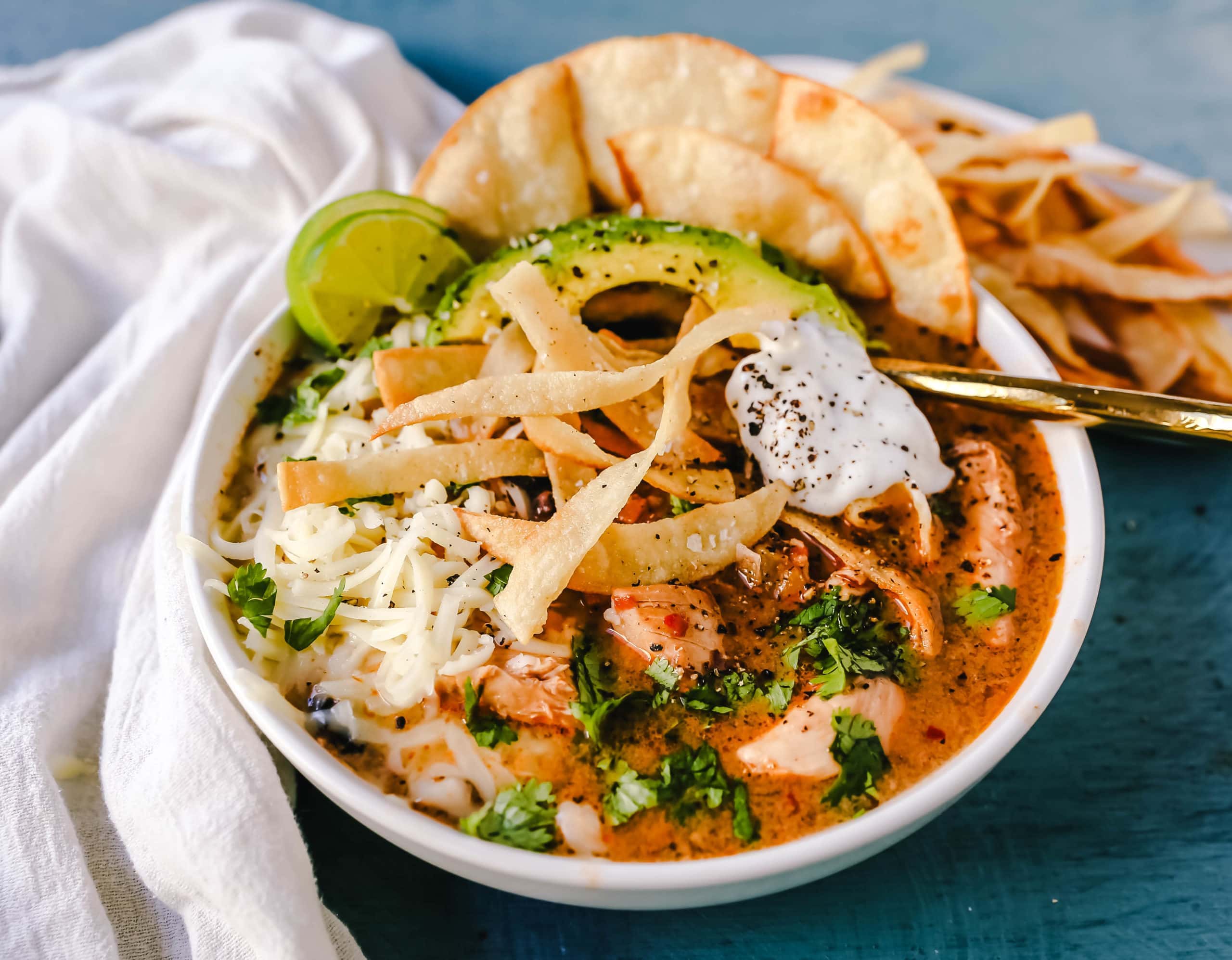 Slow Cooker Creamy Chicken Tortilla Soup Creamy, spicy, warm, and comforting creamy chicken tortilla soup all made in a crockpot! The best crockpot creamy chicken tortilla soup recipe! www.modernhoney.com #soup #chickentortillasoup #mexicanfood