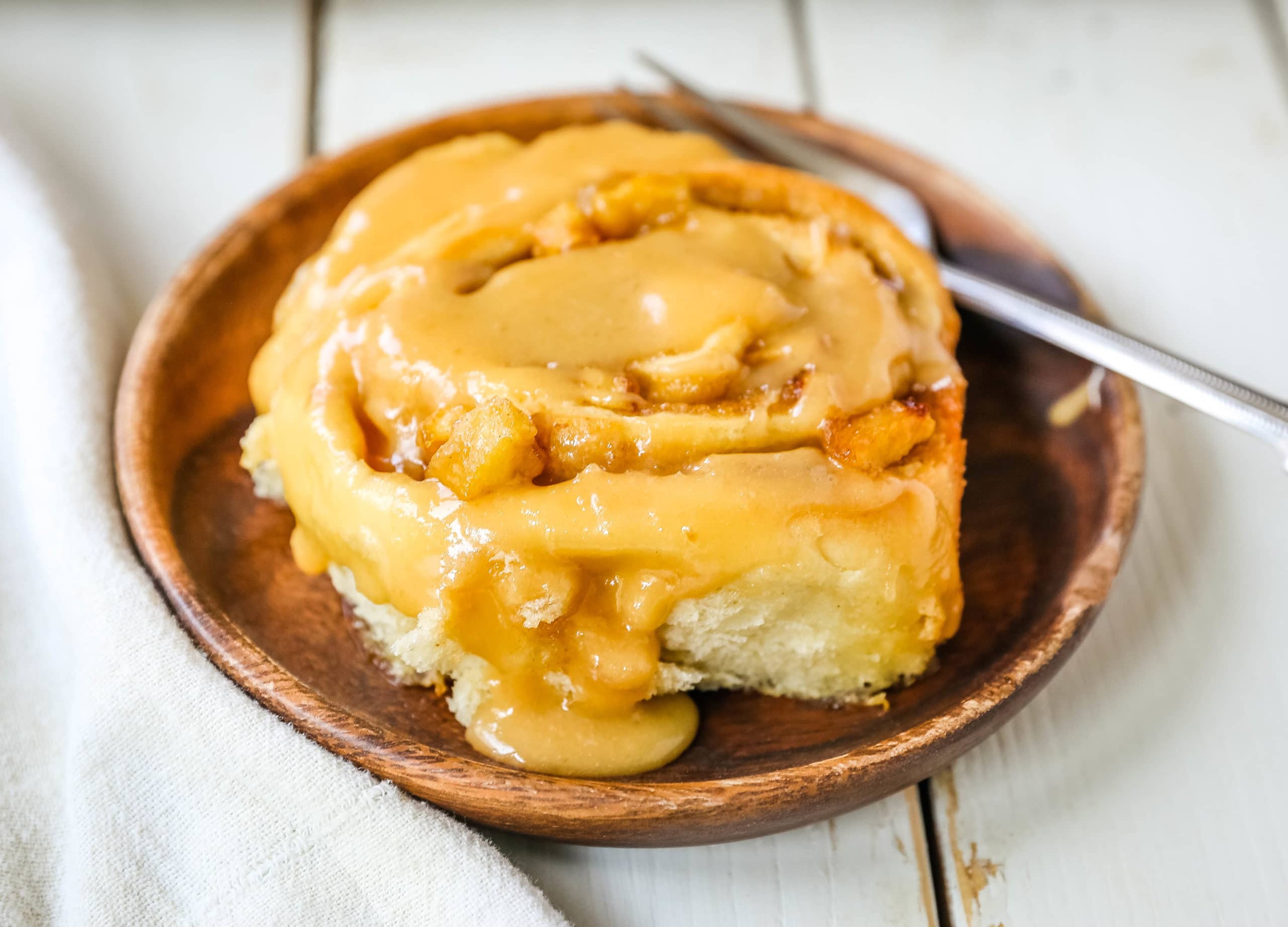 Caramel Apple Cinnamon Rolls Homemade salted caramel paired with tart apples all rolled into and baked in a sweet dough. These Salted Caramel Apple Cinnamon Rolls will knock your socks off! www.modernhoney.com #cinnamonrolls #caramelrolls #caramelapplerolls