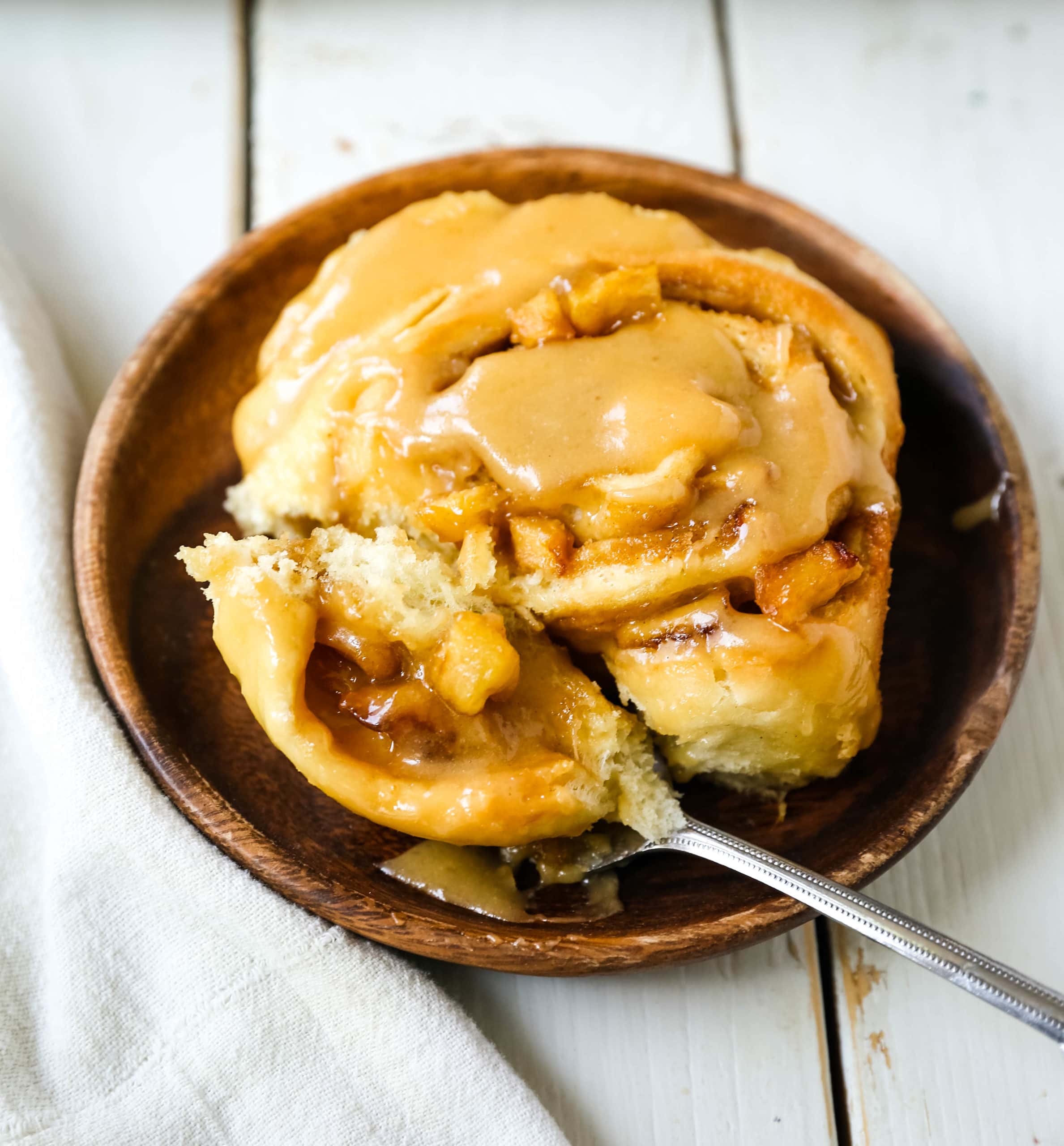 Caramel Apple Cinnamon Rolls Homemade salted caramel paired with tart apples all rolled into and baked in a sweet dough. These Salted Caramel Apple Cinnamon Rolls will knock your socks off! www.modernhoney.com #cinnamonrolls #caramelrolls #caramelapplerolls