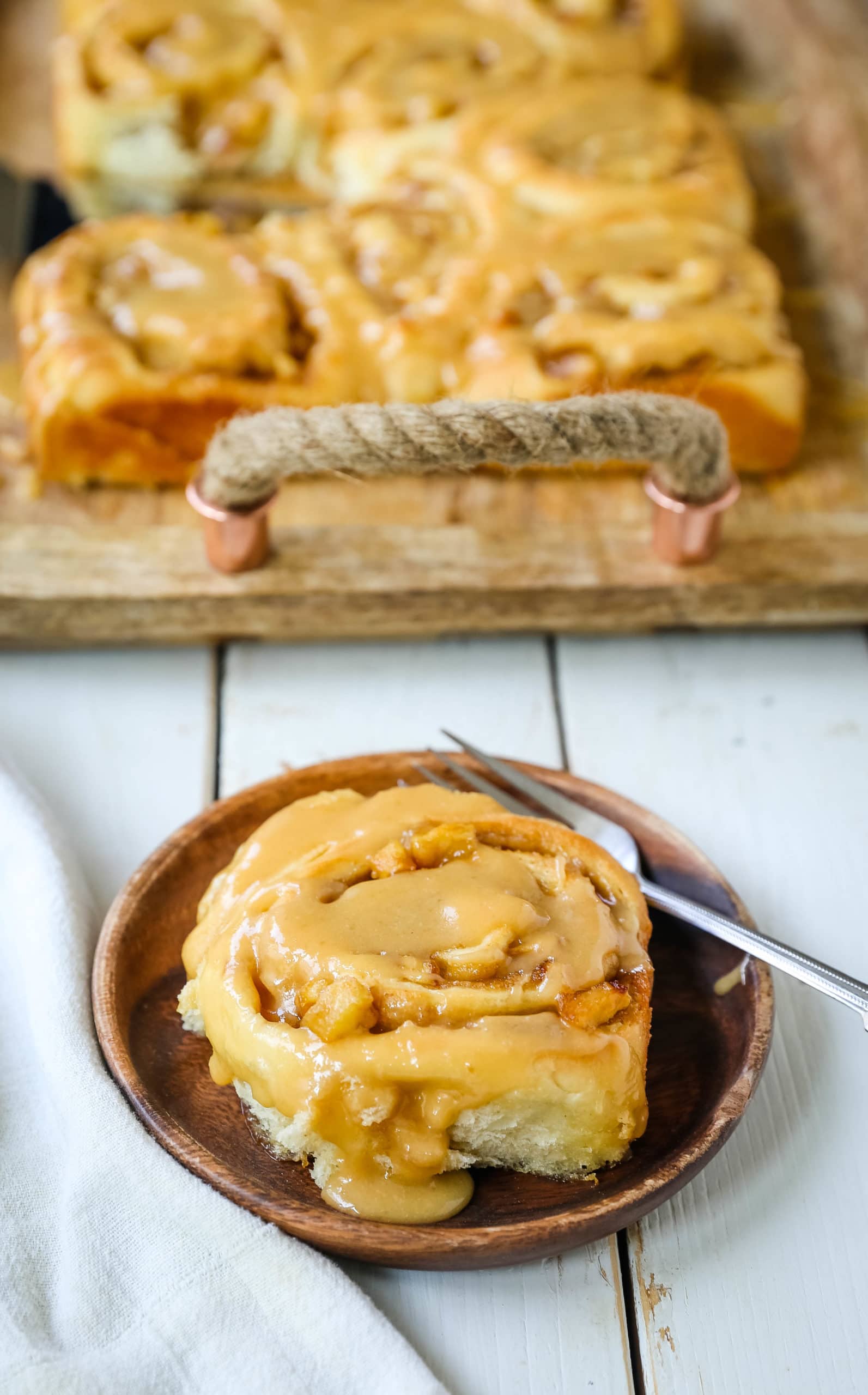 Caramel Apple Cinnamon Rolls Homemade salted caramel paired with tart apples all rolled into and baked in a sweet dough. These Salted Caramel Apple Cinnamon Rolls will knock your socks off! www.modernhoney.com #cinnamonrolls #caramelrolls #caramelapplerolls