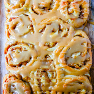 Caramel Apple Cinnamon Rolls Homemade salted caramel paired with tart apples all rolled into and baked in a sweet dough. These Salted Caramel Apple Cinnamon Rolls will knock your socks off! www.modernhoney.com #cinnamonrolls #caramelrolls #caramelapplerolls