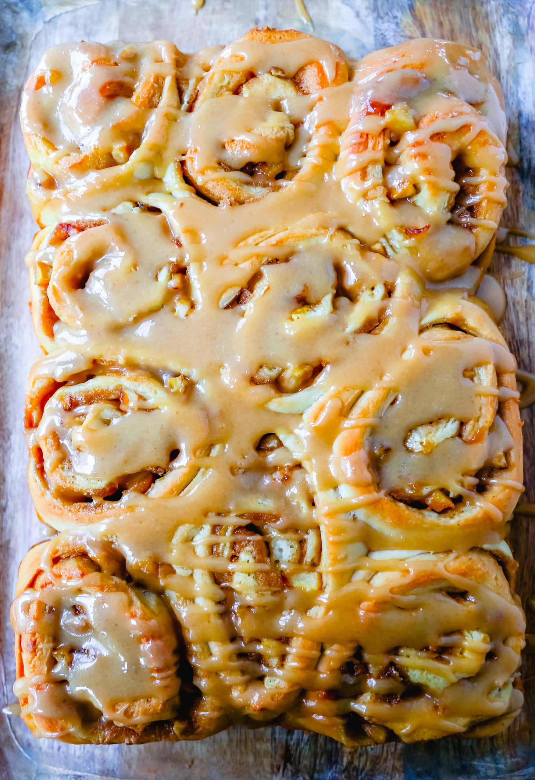 Caramel Apple Cinnamon Rolls Homemade salted caramel paired with tart apples all rolled into and baked in a sweet dough. These Salted Caramel Apple Cinnamon Rolls will knock your socks off! www.modernhoney.com #cinnamonrolls #caramelrolls #caramelapplerolls