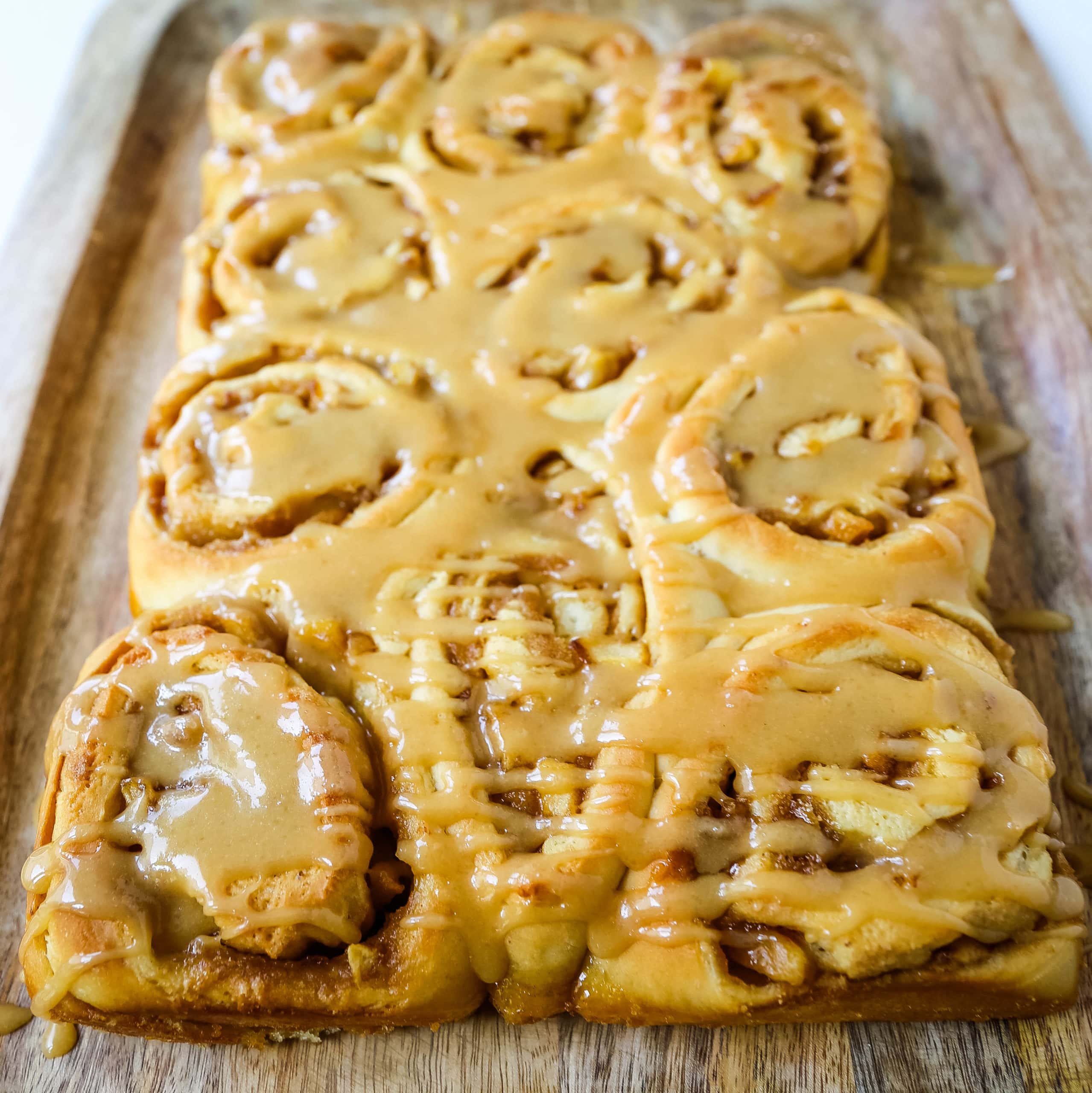 Caramel Apple Cinnamon Rolls Homemade salted caramel paired with tart apples all rolled into and baked in a sweet dough. These Salted Caramel Apple Cinnamon Rolls will knock your socks off! www.modernhoney.com #cinnamonrolls #caramelrolls #caramelapplerolls