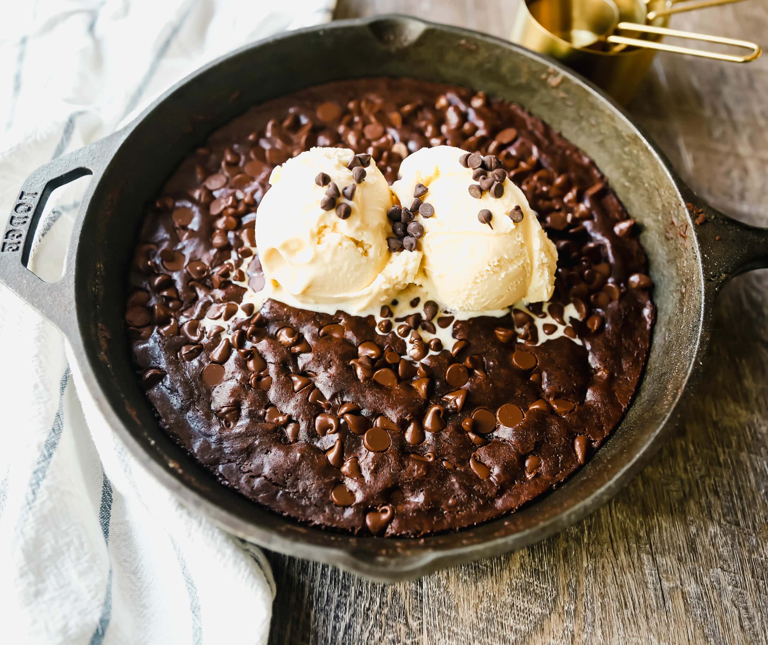 Double Chocolate Chocolate Chip Skillet Cookie Rich, chewy double chocolate chip cookie baked in a cast-iron skillet and topped with ice cream. www.modernhoney.com #doublechocolatechipskilletcookie #skilletcookie