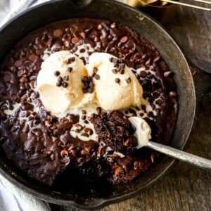 Double Chocolate Chocolate Chip Skillet Cookie Rich, chewy double chocolate chip cookie baked in a cast-iron skillet and topped with ice cream. www.modernhoney.com #doublechocolatechipskilletcookie #skilletcookie