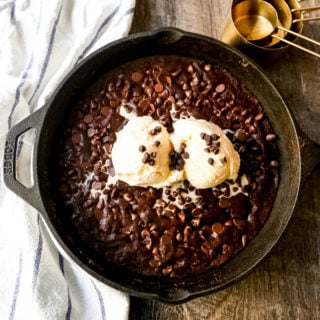 Double Chocolate Chocolate Chip Skillet Cookie Rich, chewy double chocolate chip cookie baked in a cast-iron skillet and topped with ice cream. www.modernhoney.com #doublechocolatechipskilletcookie #skilletcookie