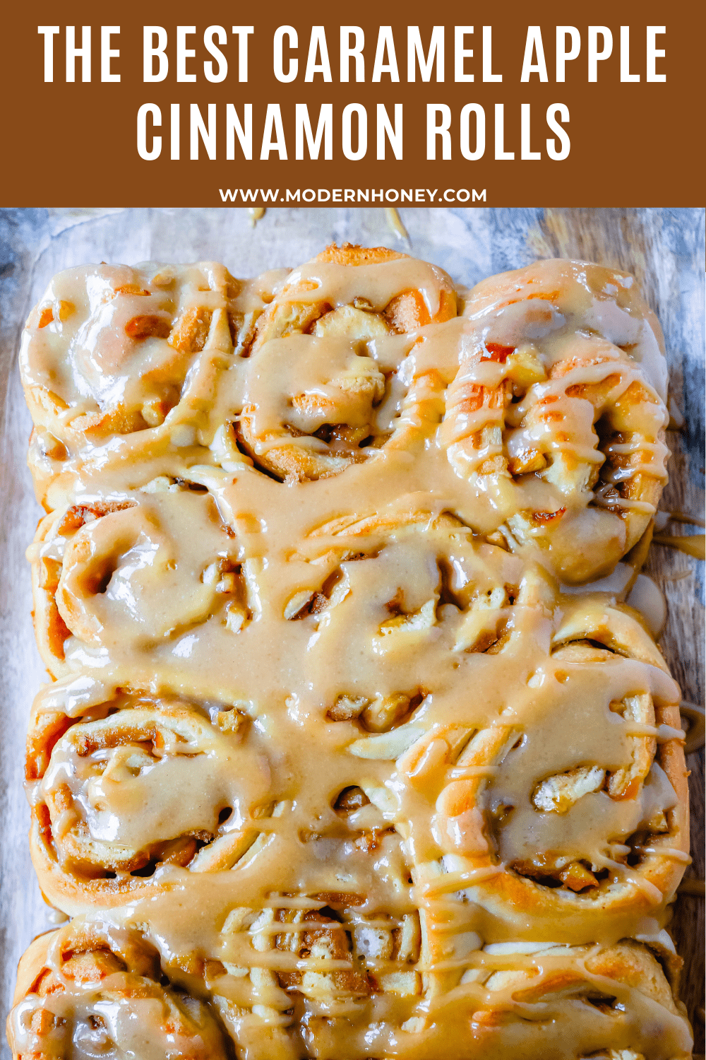 Caramel Apple Cinnamon Rolls Homemade salted caramel paired with tart apples all rolled into and baked in a sweet dough. These Salted Caramel Apple Cinnamon Rolls will knock your socks off! www.modernhoney.com #cinnamonrolls #caramelrolls #caramelapplerolls