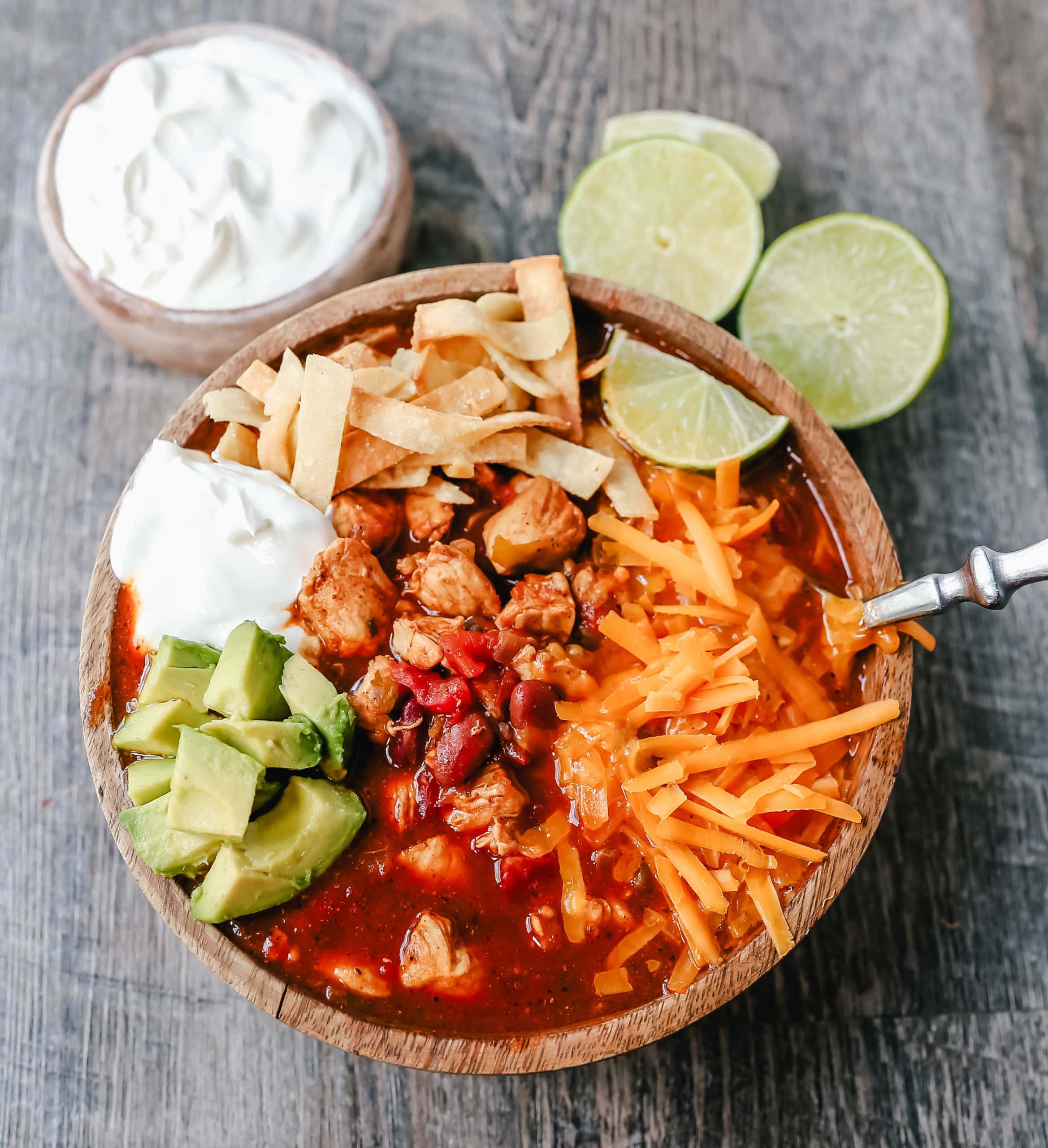 Chicken Chili. Traditional, homemade chicken chili with Mexican spices, green chilies, tomatoes, chili beans, and two secret ingredients to put it over the top! www.modernhoney.com #chili #chickenchili