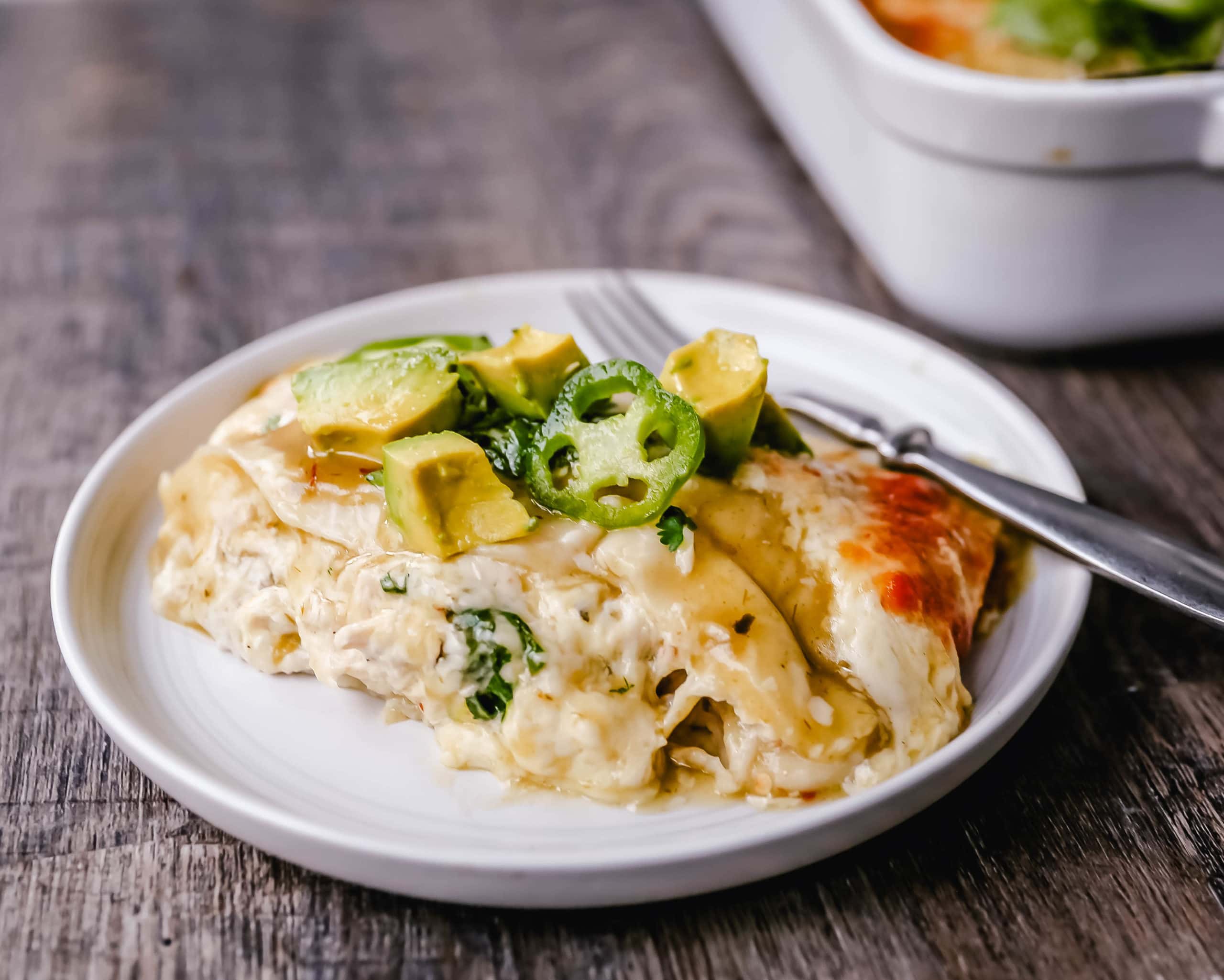 Creamy Green Chile Chicken Enchiladas Creamy chicken enchiladas stuffed with a cream cheese and sour cream green chile chicken rolled into corn tortillas and topped with green enchilada sauce and pepper jack cheese. The best creamy chicken enchiladas recipe! www.moderrnhoney.com #enchiladas #mexicanfood