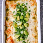 Creamy Green Chile Chicken Enchiladas Creamy chicken enchiladas stuffed with a cream cheese and sour cream green chile chicken rolled into corn tortillas and topped with green enchilada sauce and pepper jack cheese. The best creamy chicken enchiladas recipe! www.moderrnhoney.com #enchiladas #mexicanfood