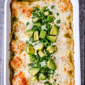 Creamy Green Chile Chicken Enchiladas Creamy chicken enchiladas stuffed with a cream cheese and sour cream green chile chicken rolled into corn tortillas and topped with green enchilada sauce and pepper jack cheese. The best creamy chicken enchiladas recipe! www.moderrnhoney.com #enchiladas #mexicanfood